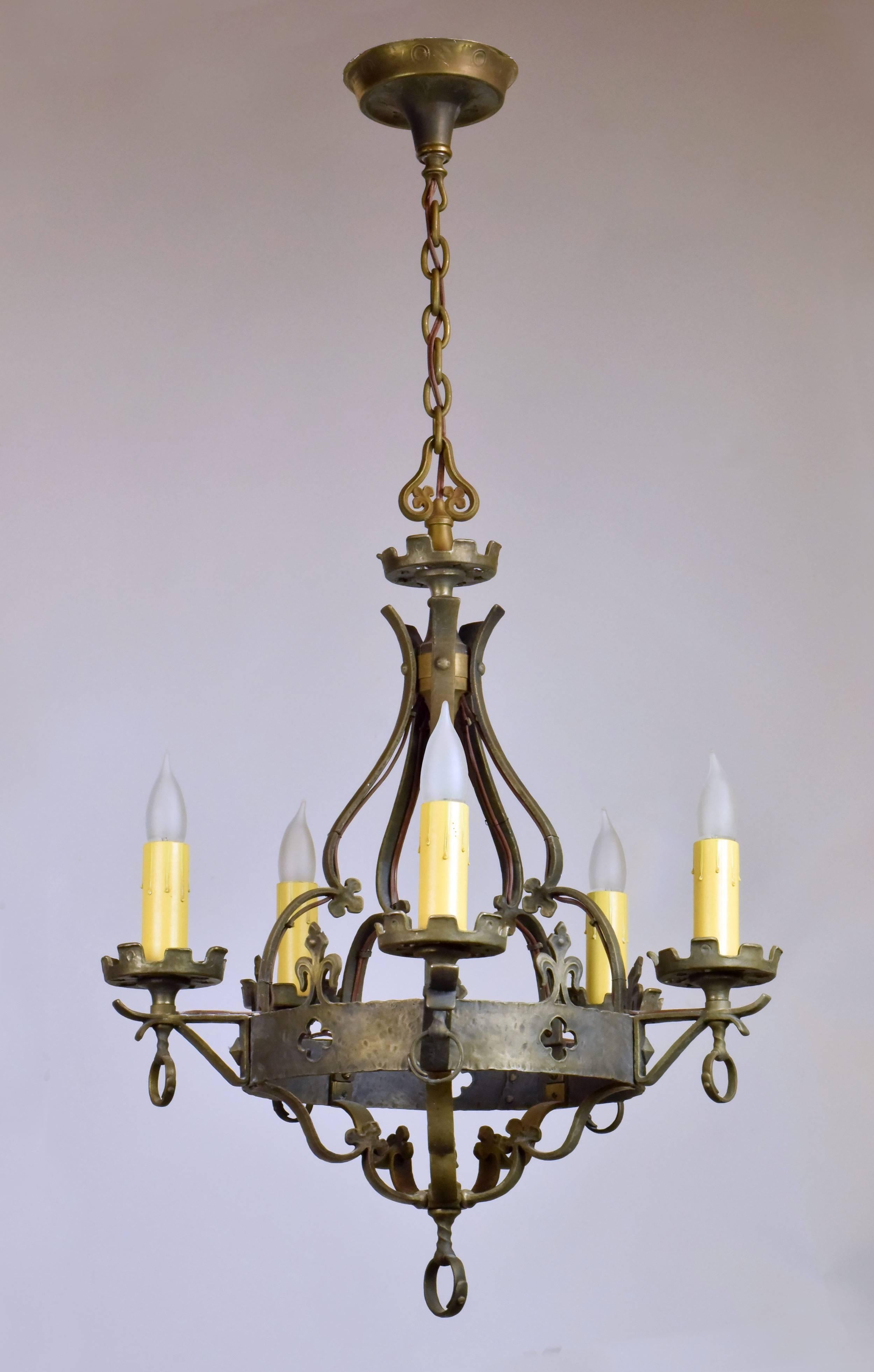 This heavy cast bronze five-candle chandelier is embellished with decorative quatrefoil and fleur-de-lis designs, both common in Tudor design. If you're looking for quality and craftsmanship and old world charm, this fixture has both in