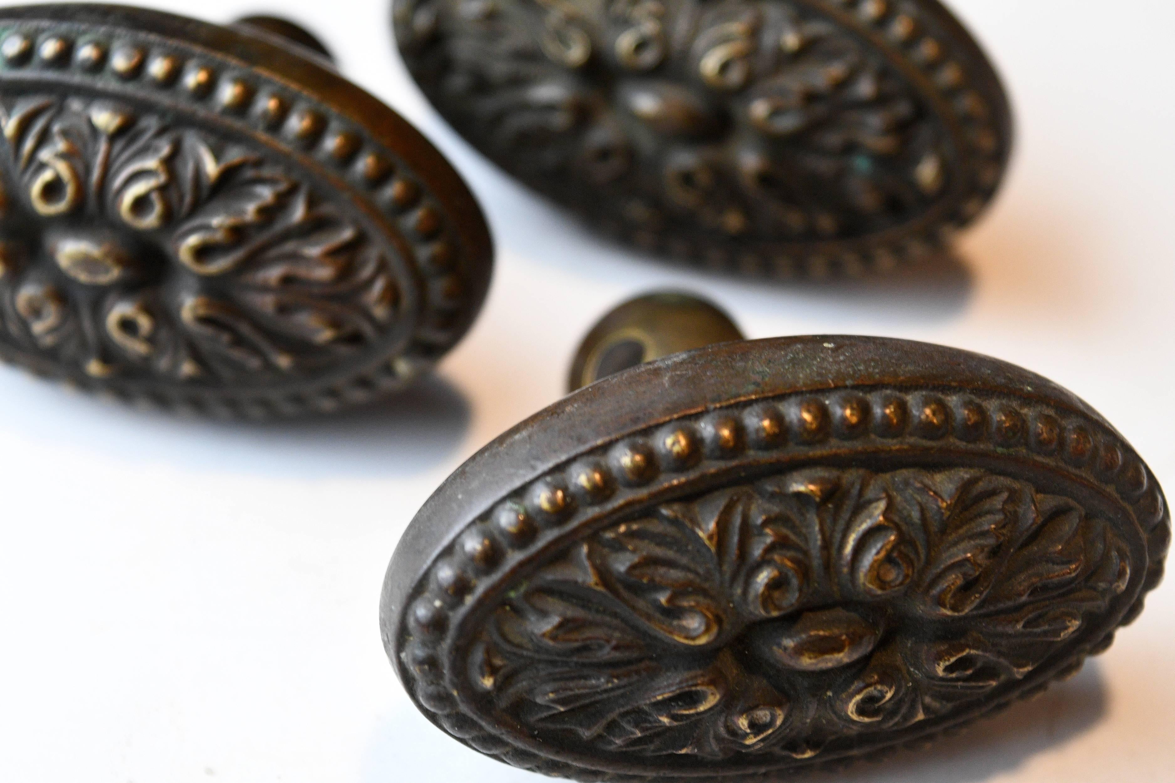 Small rococo style, elongated oval doorknobs. Decorated with curvy, leafy patterns.
3 available