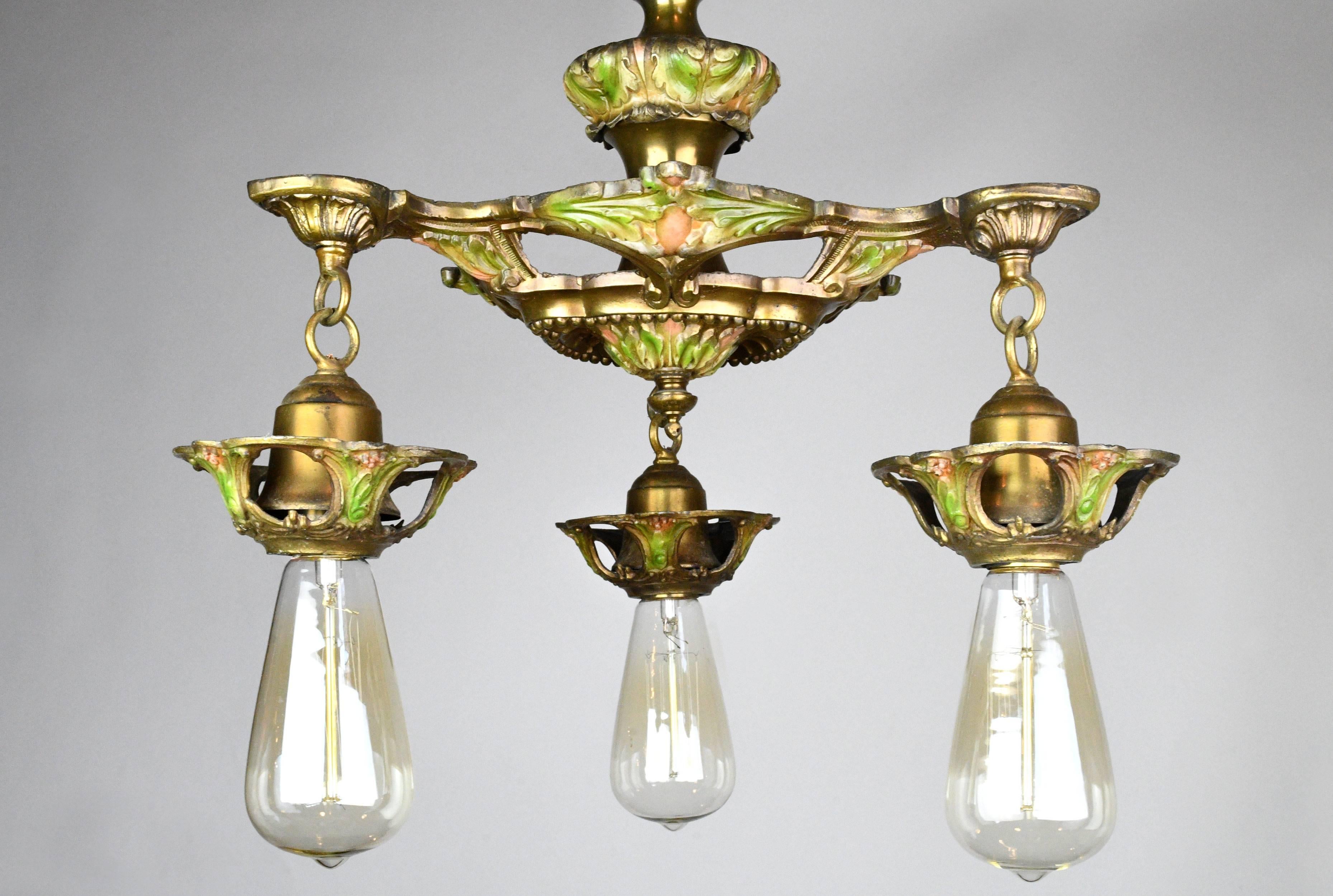Yellow and rose colored painted details adorn this intricately detailed three-light lead chandelier. Pair with Edison bulbs for a look that's aged to perfection.

We find that early antique lighting was designed as objects of art and we treat each