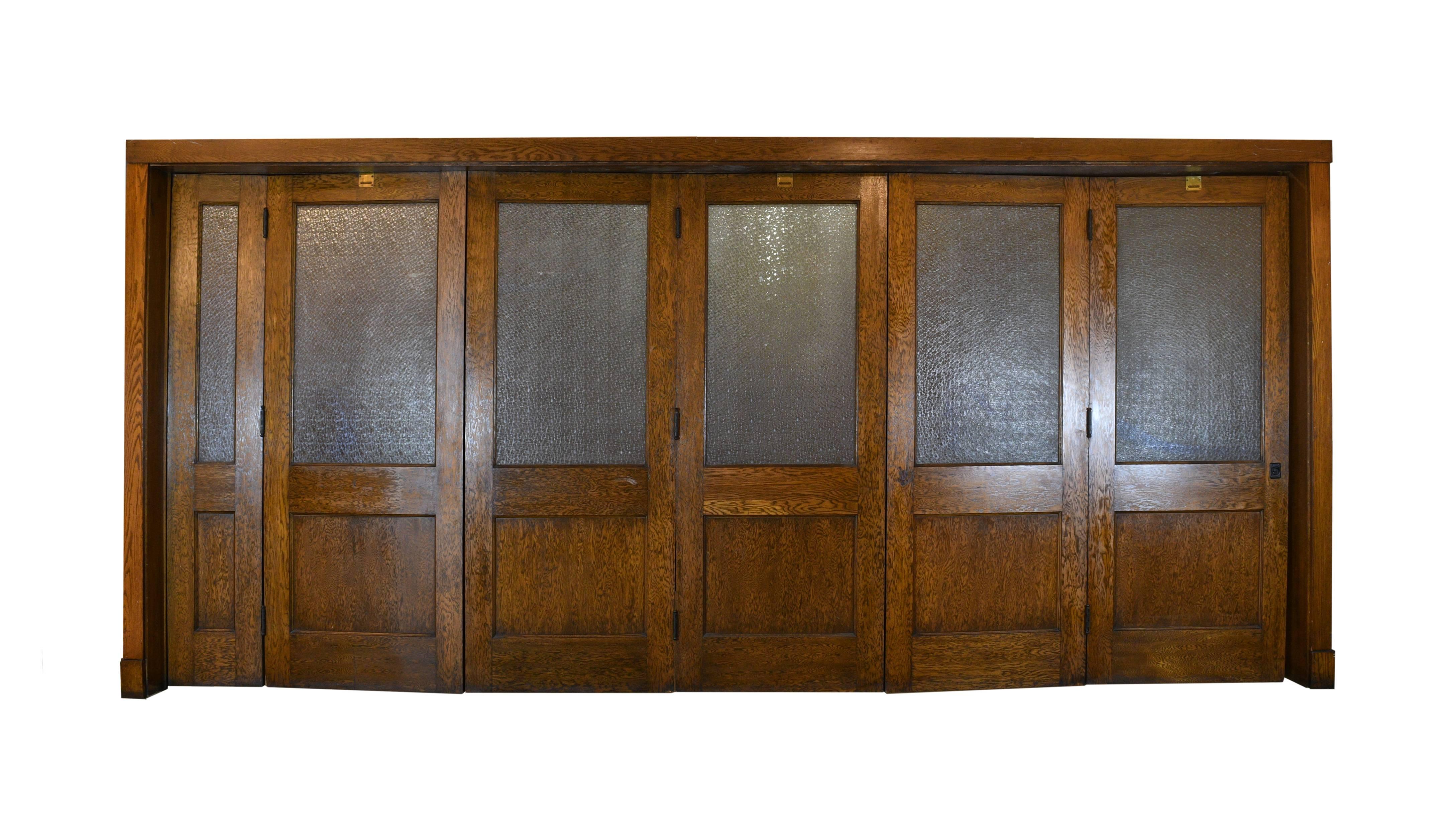 This huge set of bi-fold doors is from a school in Youngstown, Ohio. Both the wood and the textured, snowflake glass are kept with care and every part of the door functions extremely well. When closed, the glass allows light to go through while at