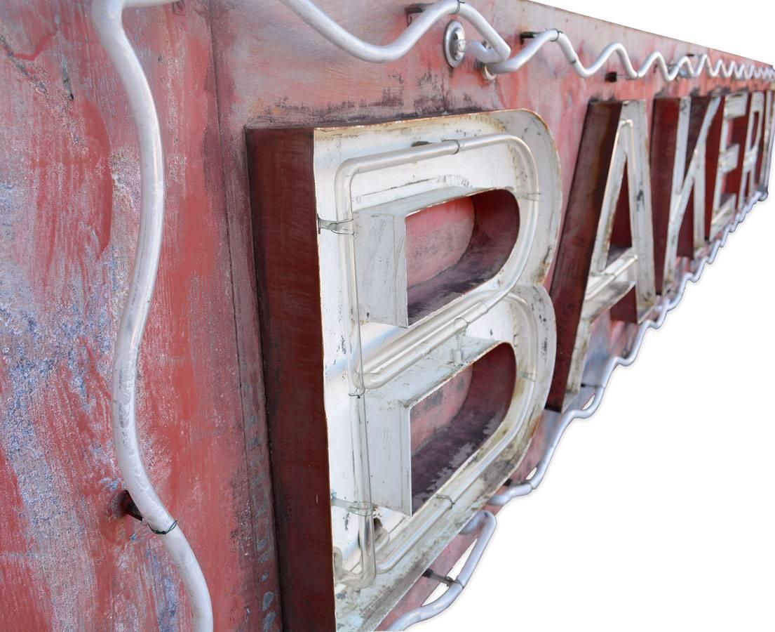 Rescued from a little town in Northern Minnesota, this sign once hung across the entire building entrance on main street.  Original red paint is worn to the perfect patina and at 18.5 foot in length- its large scale makes quite a statement!