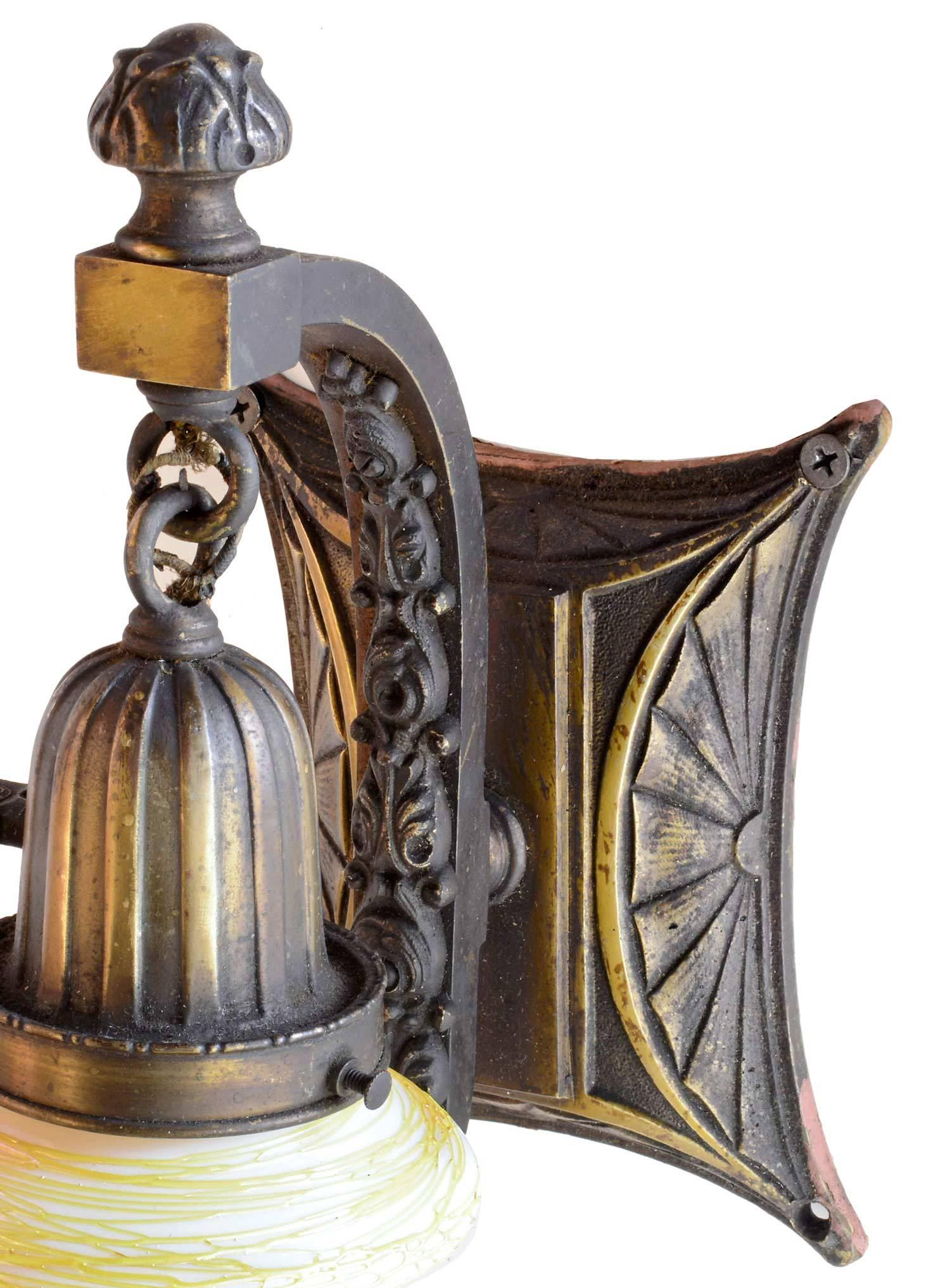 Finely cast sconce with floral details, fluted cup, and sunburst pattern. Includes original signed Quezal shade.

We find that early antique lighting was designed as objects of art and we treat each fixture with careful attention to preserve