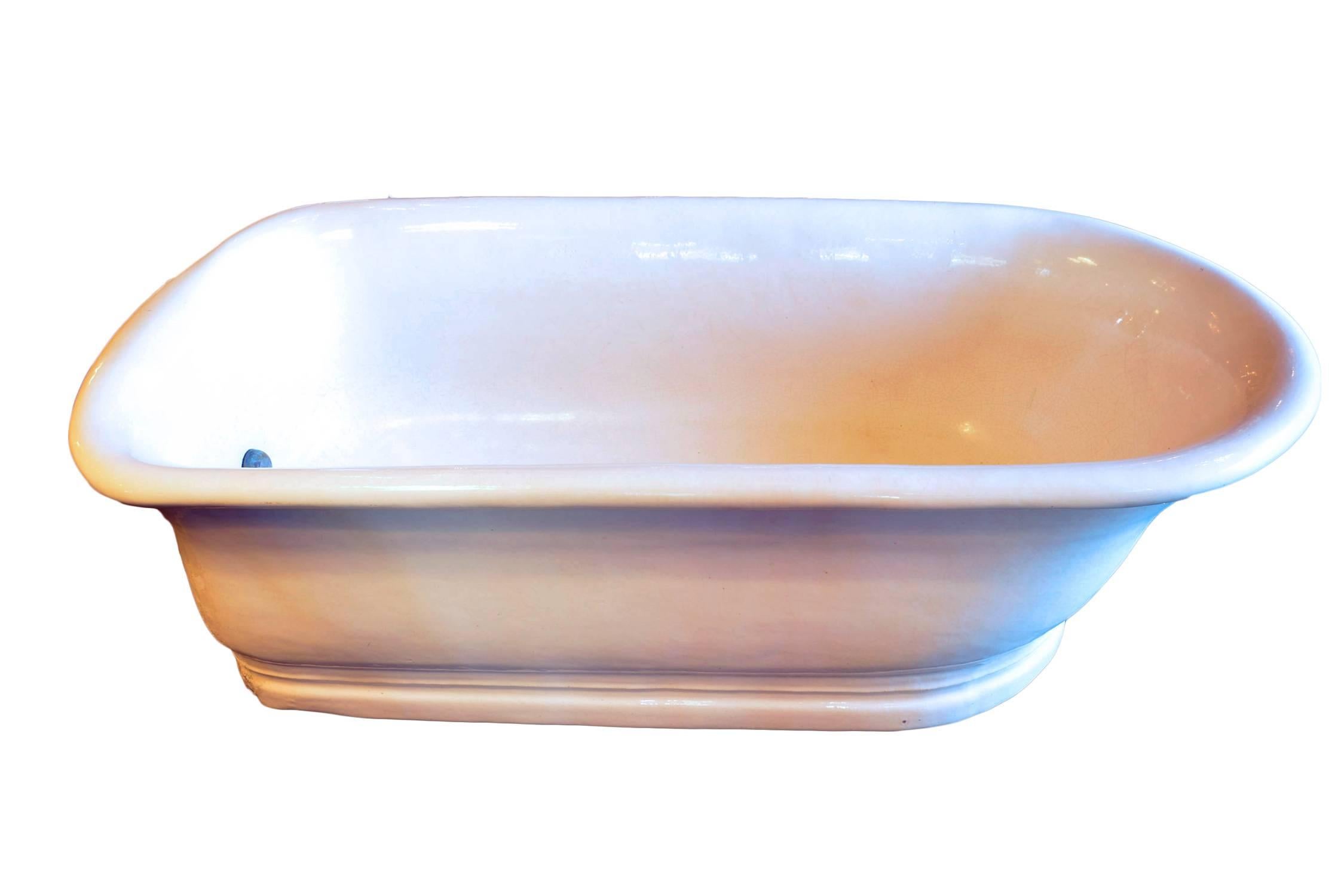 A beautiful china bathtub from the early 1900s. It is in perfect condition, without chips or cracks and with mild crazing throughout the original glaze.
