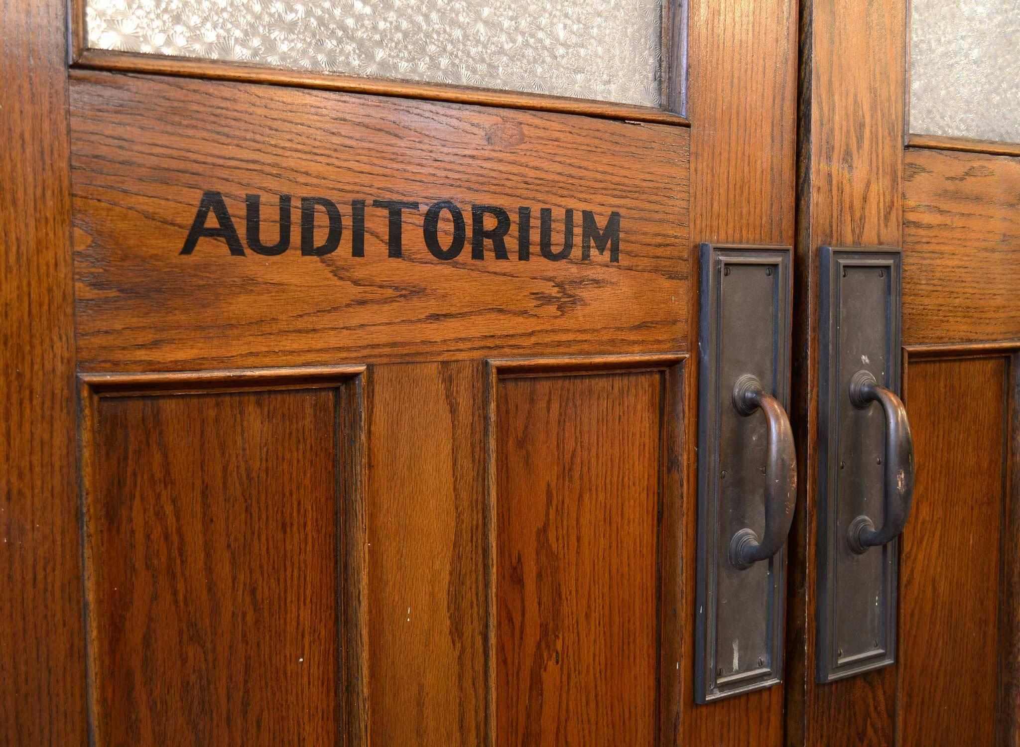 This pair of original school auditorium doors feature original textured glass, cast brass handles and pushplates, hinges and jamb.  Great for residential or commercial use.  