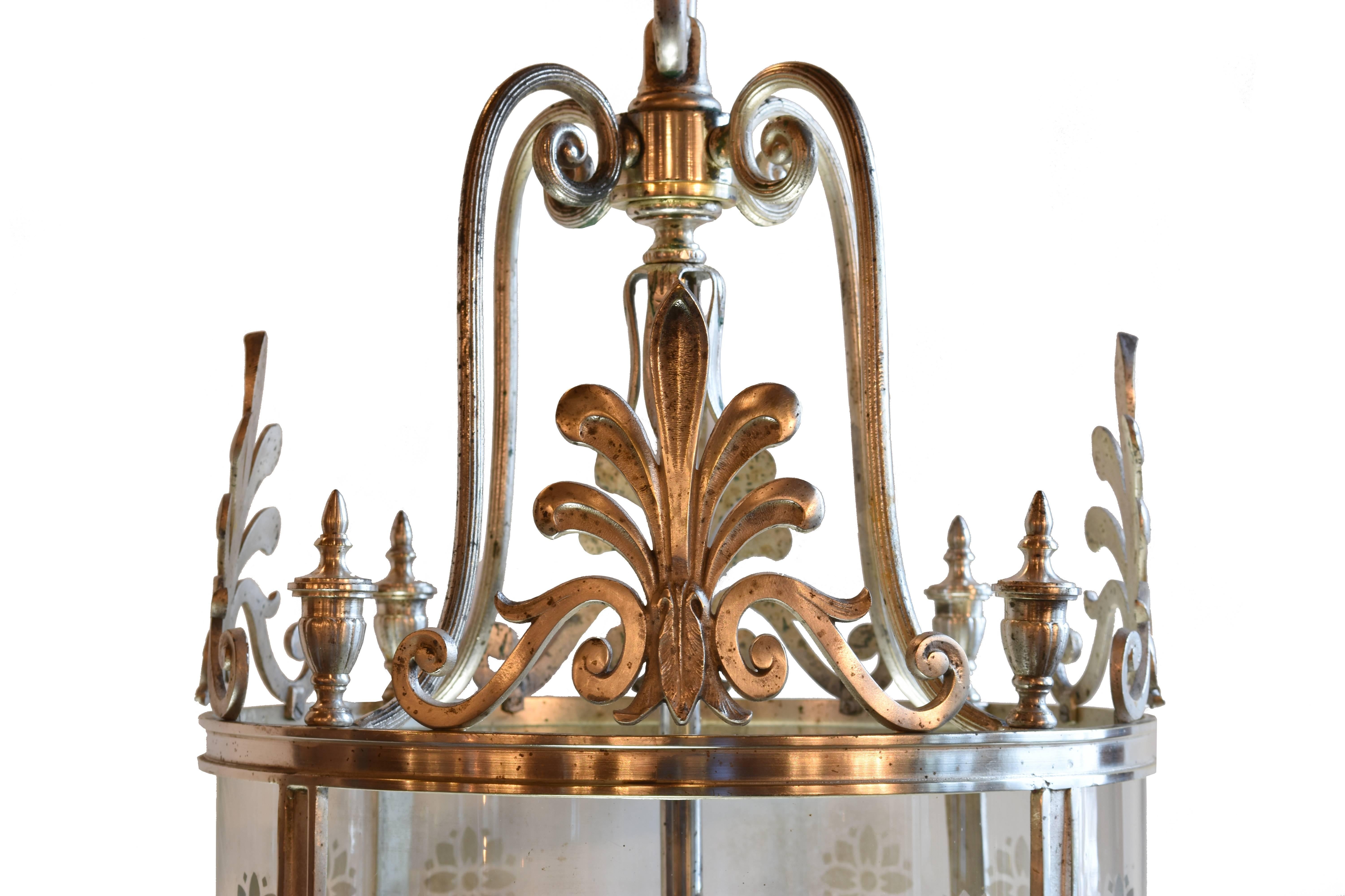 Created in 1927, these pendants originally came from a Downtown Chicago car dealership where no expense was spared. Silver plate over brass, each pendant features a seven light cluster body, cast finials, Federal style fans, and a stylized etched