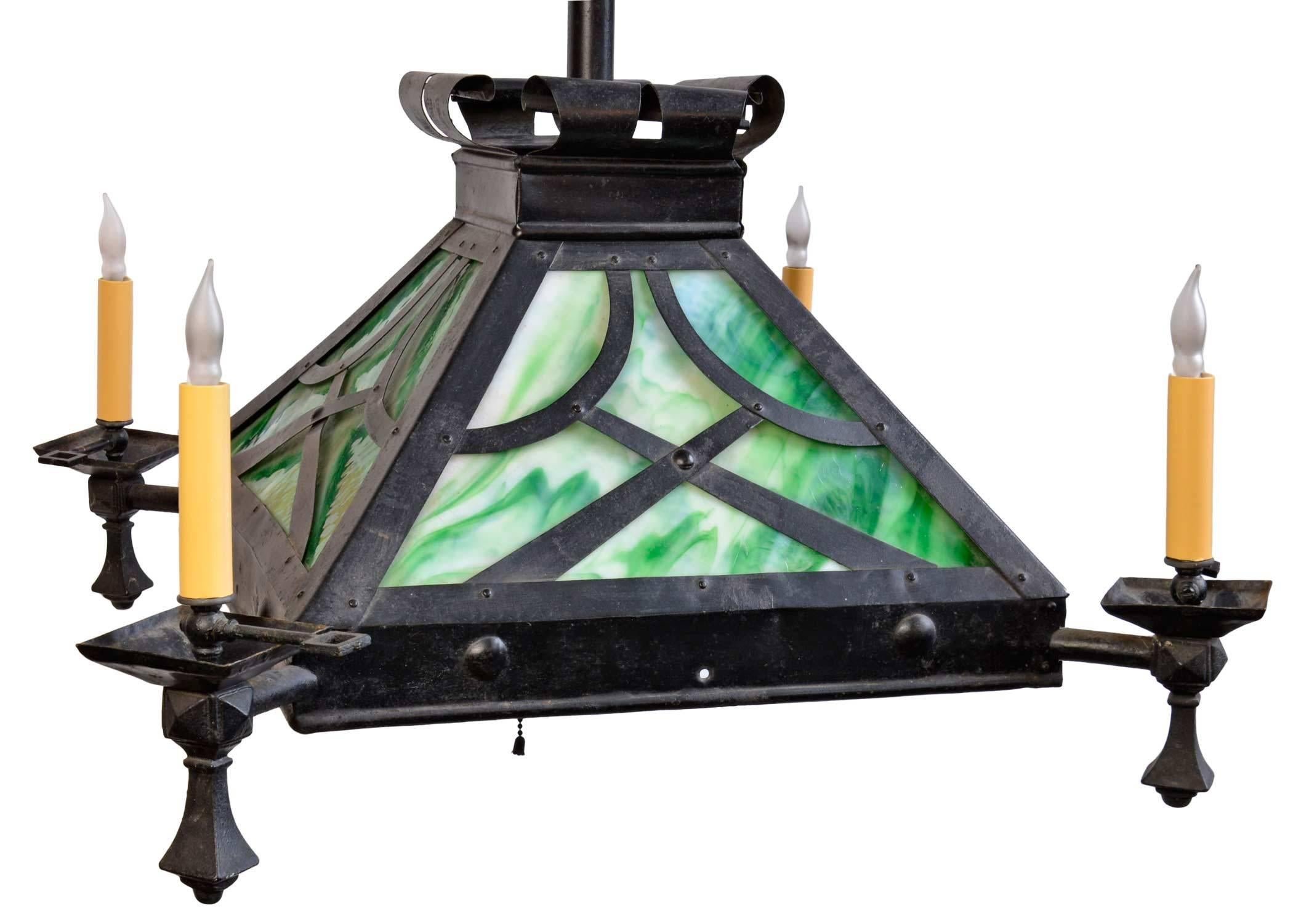 This early original American Craftsman style fixture in iron features  emerald green slag glass, iron finials, gas keys, and original canopy. The four arms and the center light within have been converted to electric and the fixture is ready to