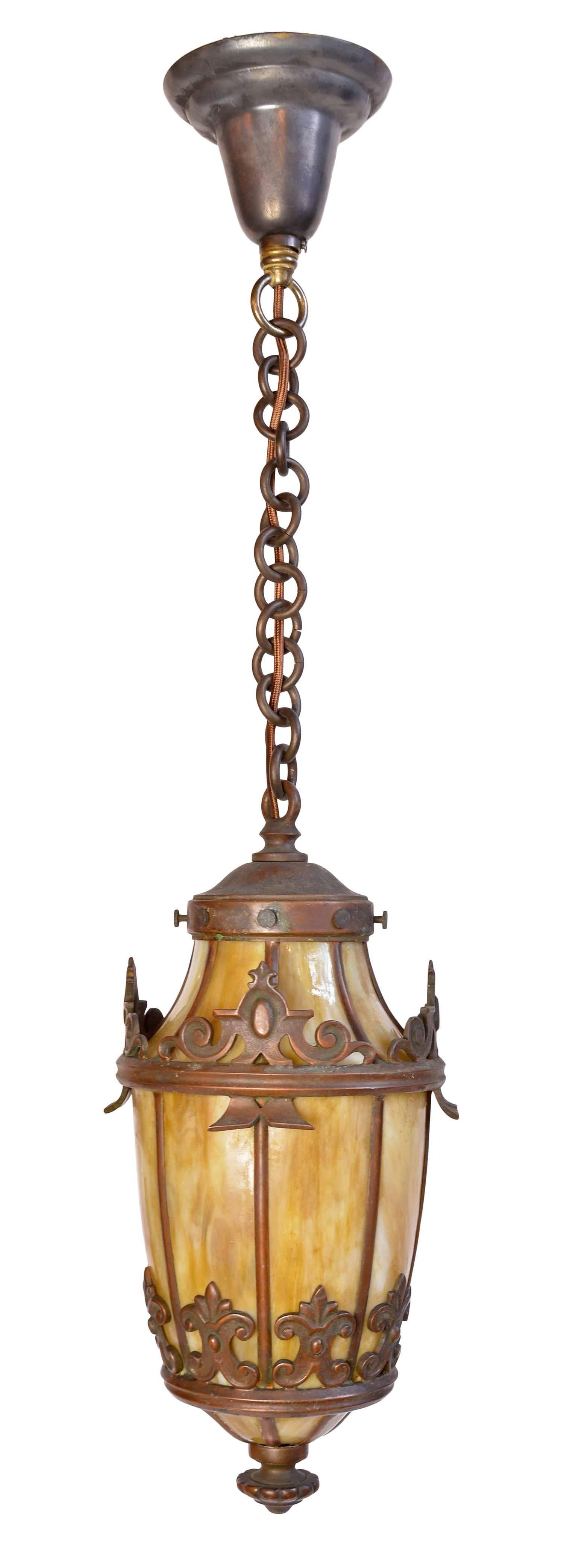 These pendants are made of cast bronze with heavy finials and decorative fleur-de-lis details. Each feature a rich series of bent panels in warm yellow. The fixture alone is 15" and height of the overall light is adjustable. Quantity