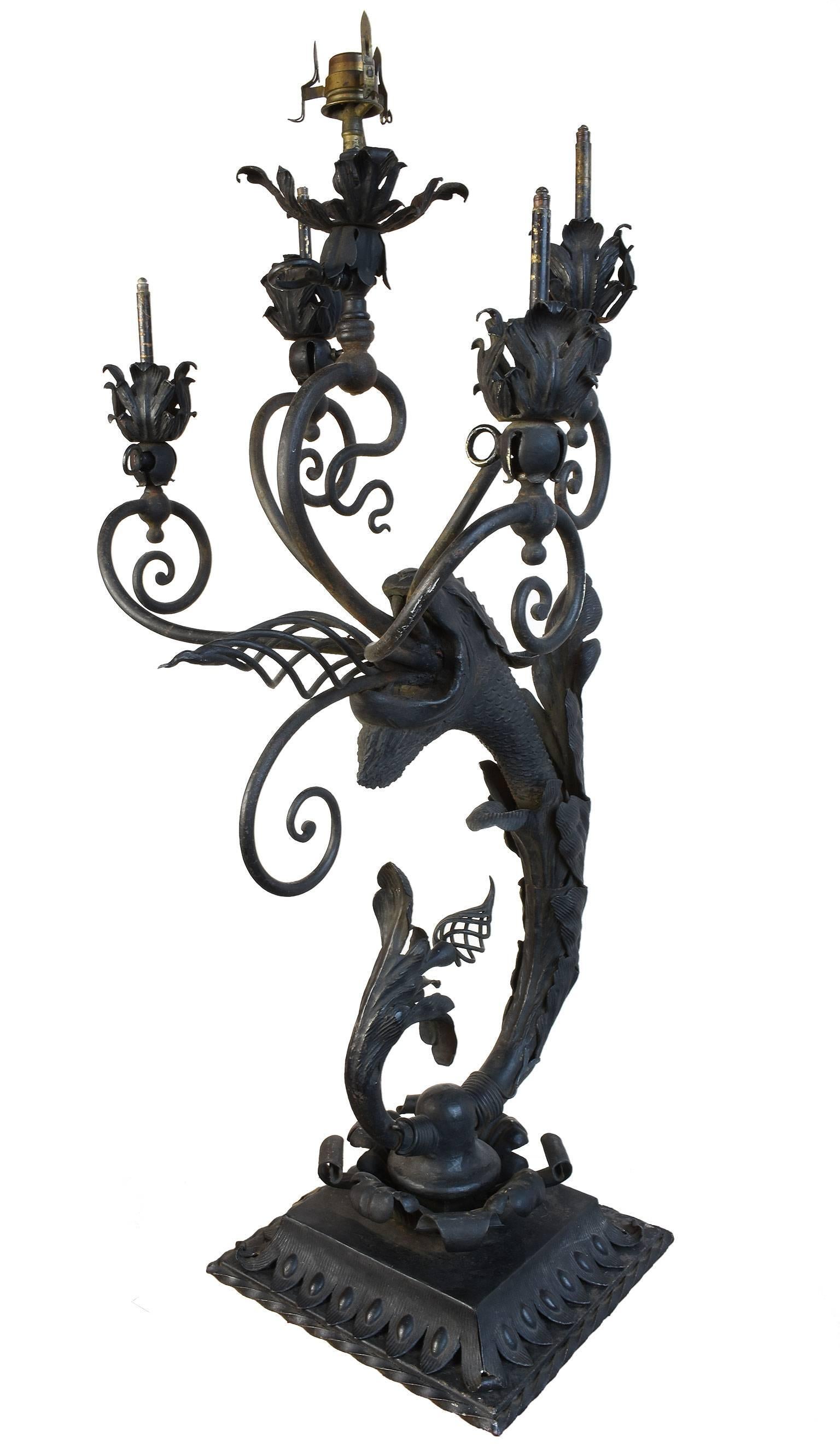 This is a rare Victorian newel post light that is created to look like a 'fire breathing dragon'. Its casting is magnificent and magical! This fixture comes complete with its original cast iron base, five gas burners, and whimsical acanthus leaf and