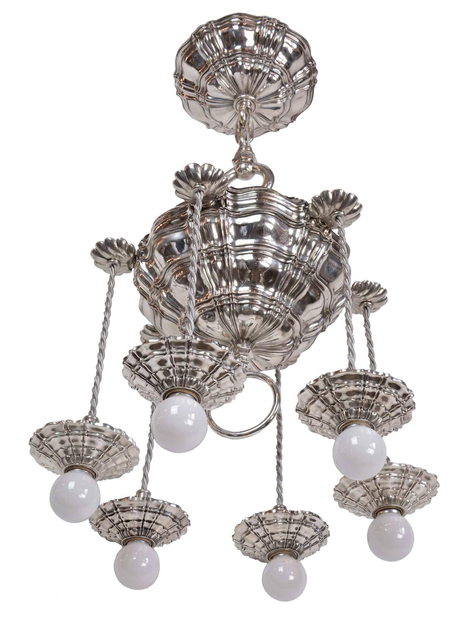 This is an unusual and exceptional example of early Caldwell lighting and is a true work of art. The silver finish is over bronze, polished to reflect light and highlight the wonderful cascading pattern within the body of the light and on each