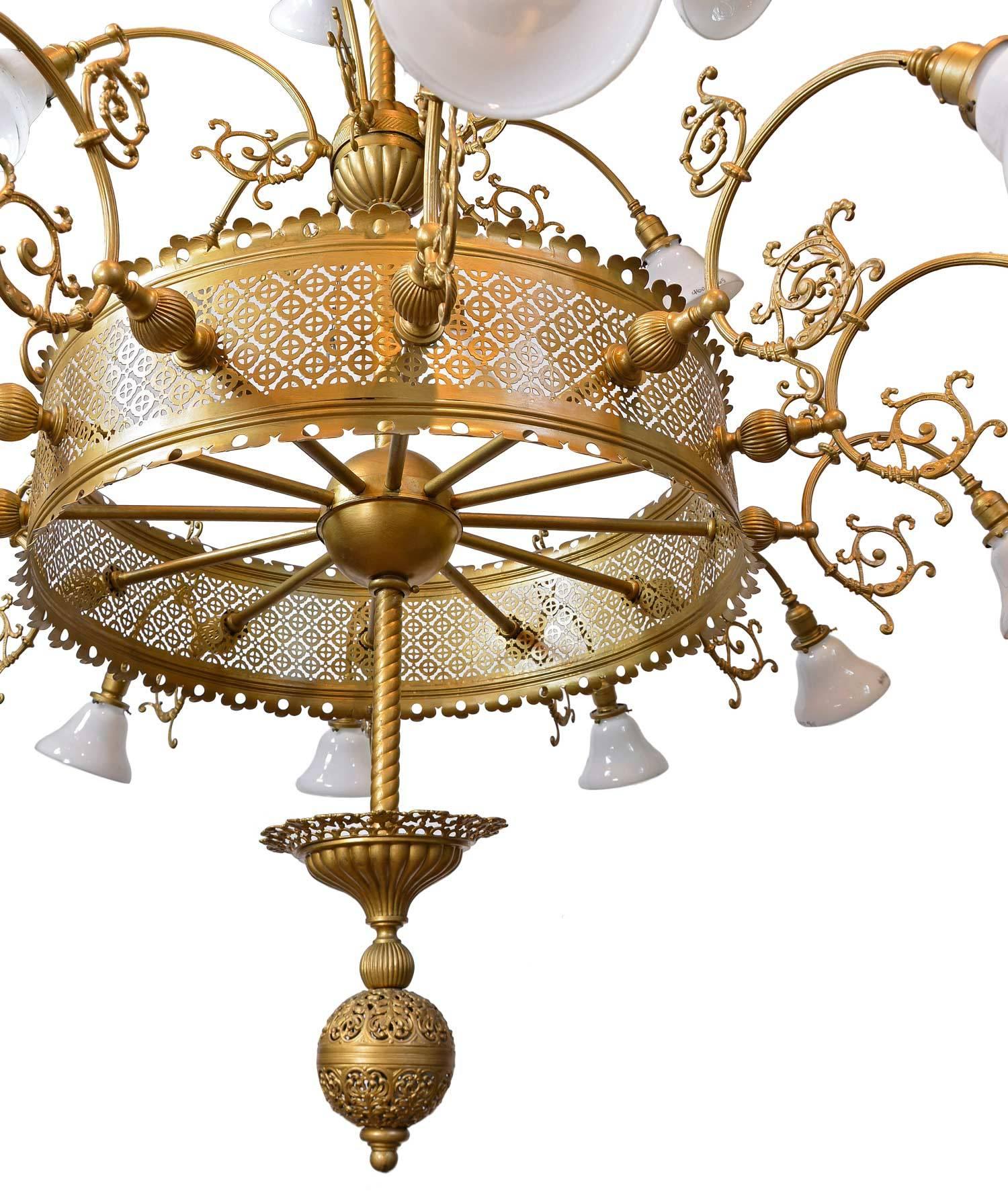 This grand, large-scale chandelier has twenty-one-arms and original milk glass shades. The fixture has Gothic details and filagree throughout, as well as an extra large canopy and decorative finial. Original painted finish over brass.

We find that