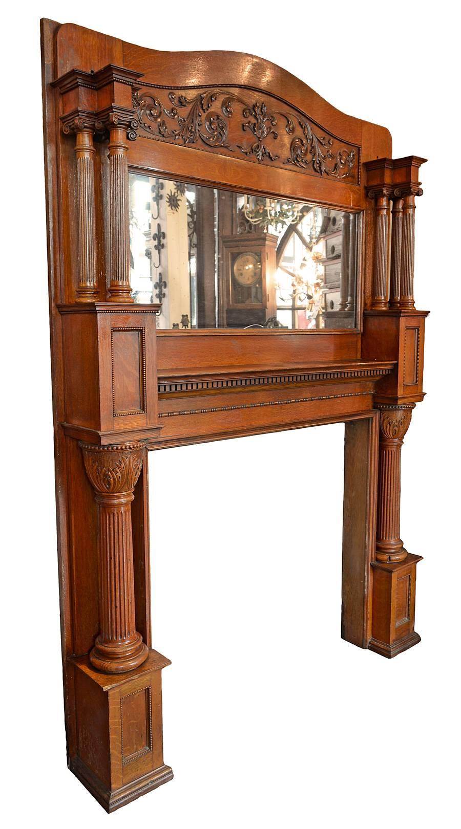 Great piece with original mirror, carved capitals Decorative oak Victorian mantel with mirror, and wonderful carved cartouche. 
Overall: 88