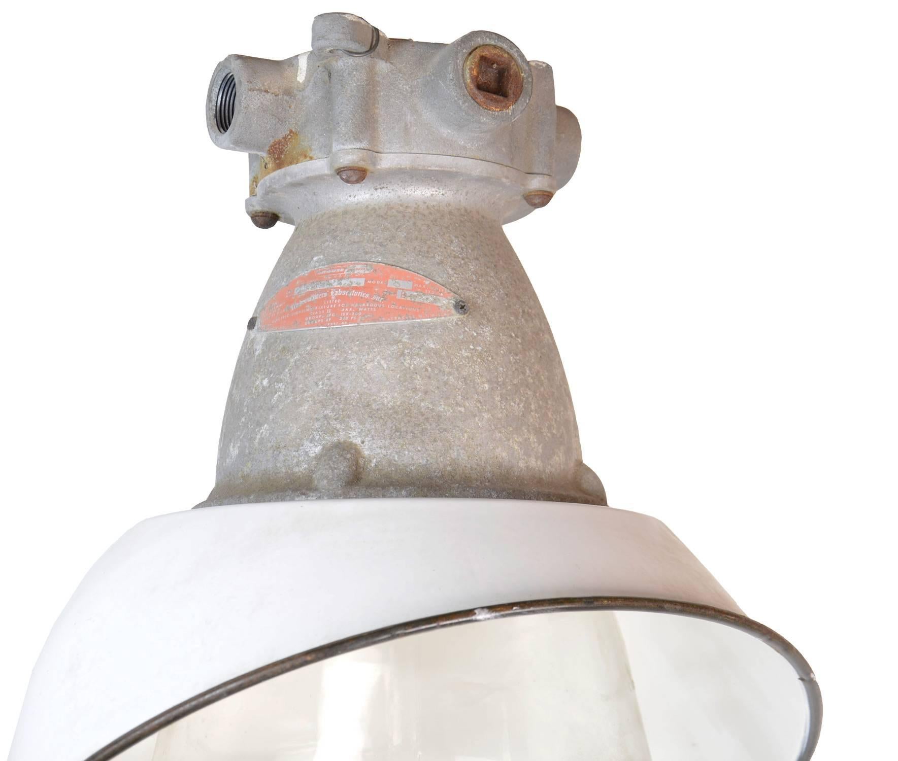 Cast aluminum warehouse "fixture for hazardous locations" with white enameled steel 45 degree angled shade and explosion proof globe by Crouse-Hinds from Syracuse, N.Y.