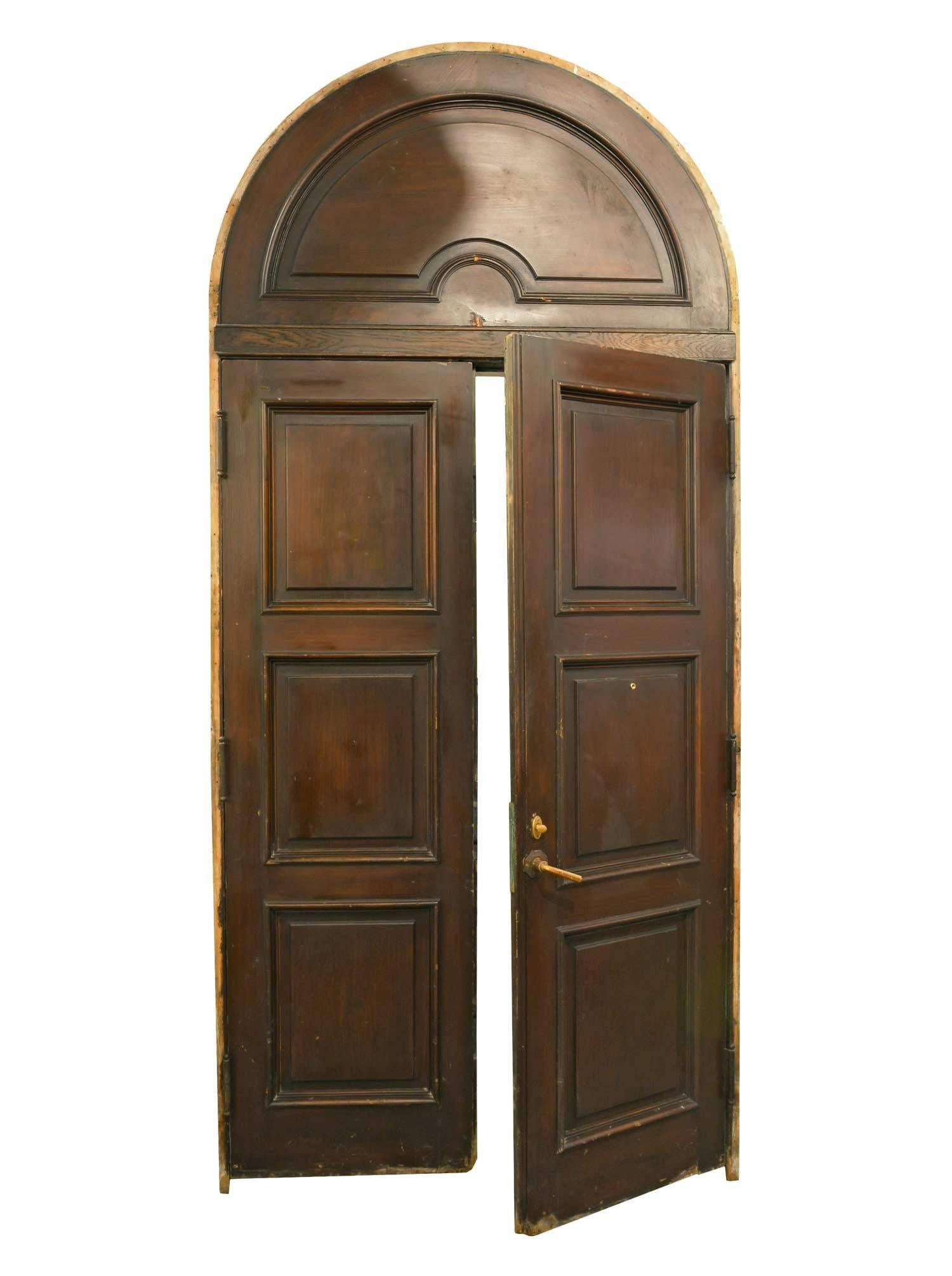 This set of Colonial Revival-style doors is impressive in height and in its simple design. One side in stained oak, the other painted. It comes complete with its original jamb and hardware. 

The door unit is 117
