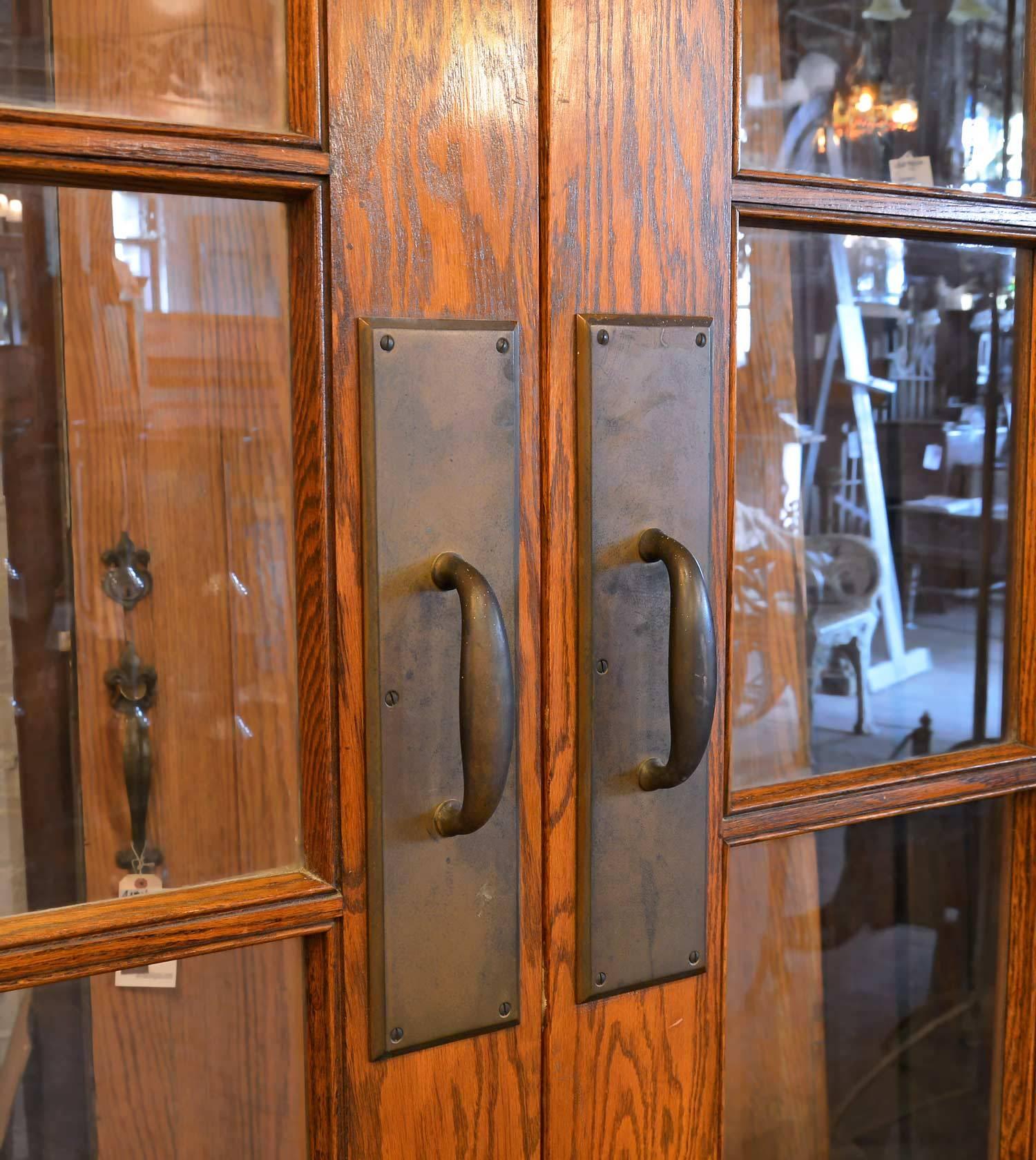 Originally from a school, this door is the epidome of early commercial construction. Red oak with a pronounced grain was used to frame out the multiple panels of original wavy glass. Perfect for new construction, residential or otherwise. Doors
