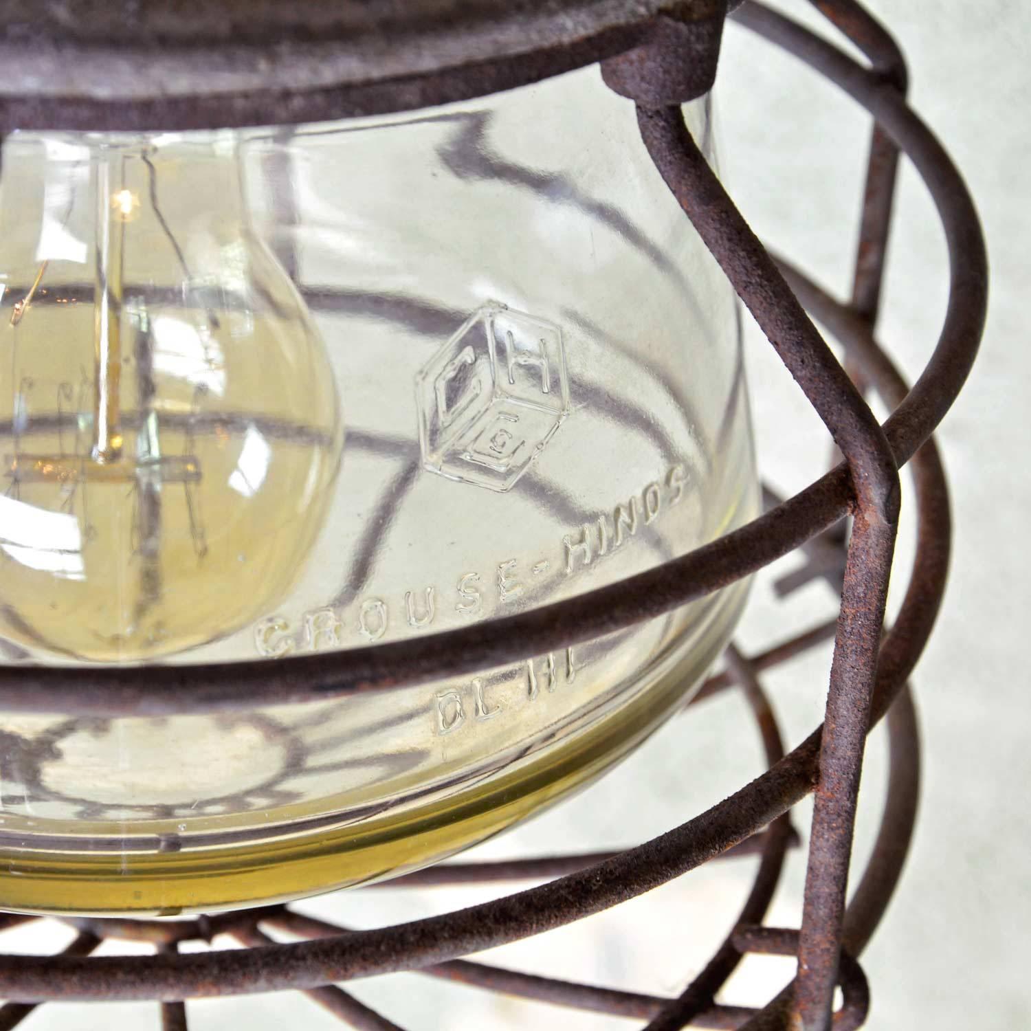 This Industrial pendant by Crouse-Hinds of Syracuse, NY features wonderful thick, original glass, an aluminum body and steel-caged explosion proof glass. Vintage piece from the 1930s with industrial character!

We find that early antique lighting