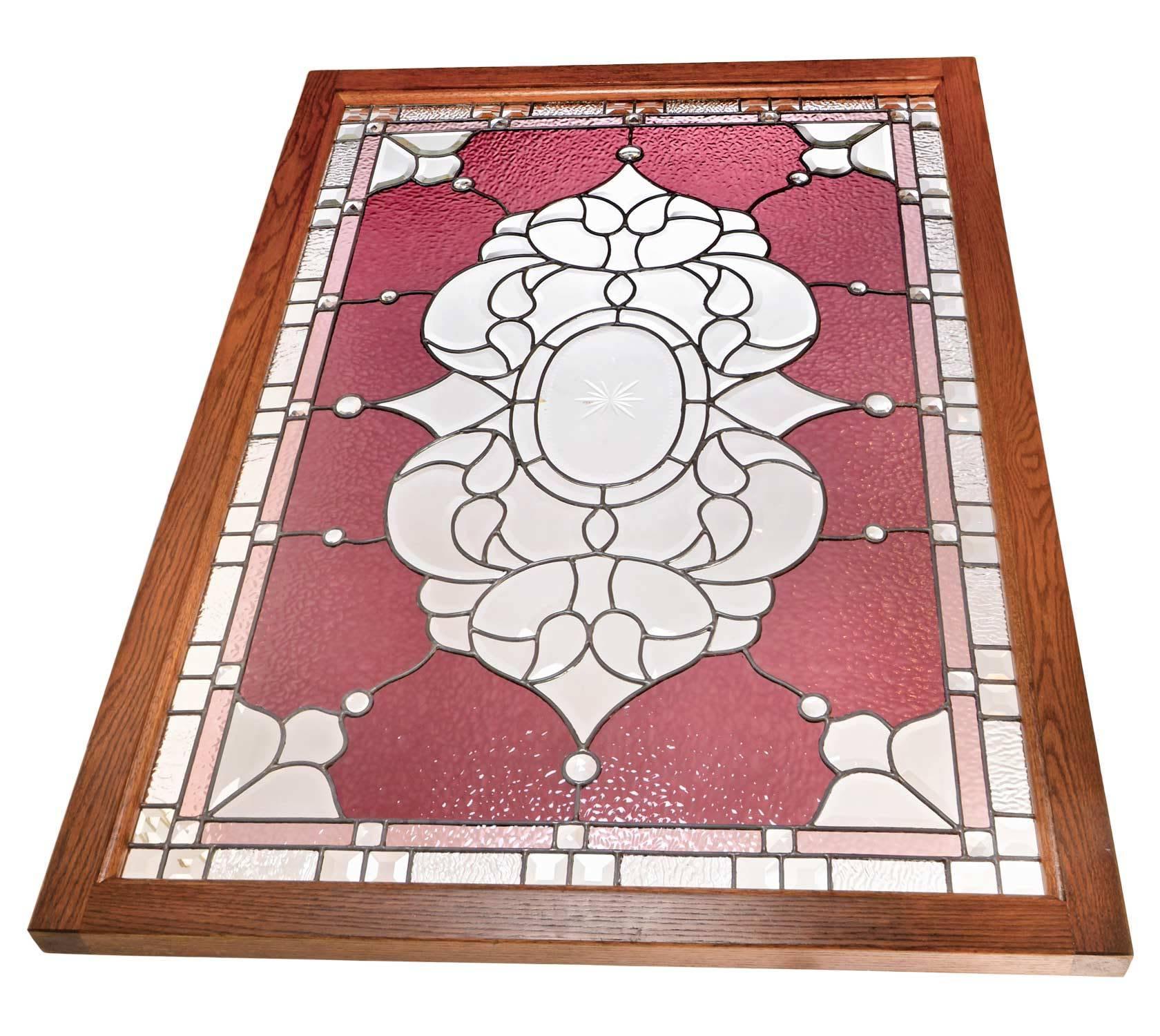 This landing window has a variety of early American glass maker techniques and a design, while symmetrical also juxtaposes geometry with fancifuls curves to add to the wonderful contrast of stained and beveled glass. Notable features include the