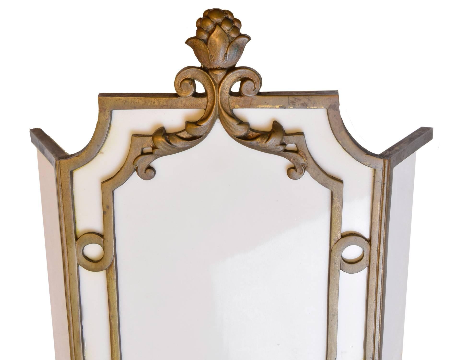 This pair of cast bronze sconces have elegant details from the 1920s and create a lovely effect when illumated on a wall. Milk glass warms with a rich glow, creating a silhouette of the beaux art design. Created by the sterling bronze Co. New York,
