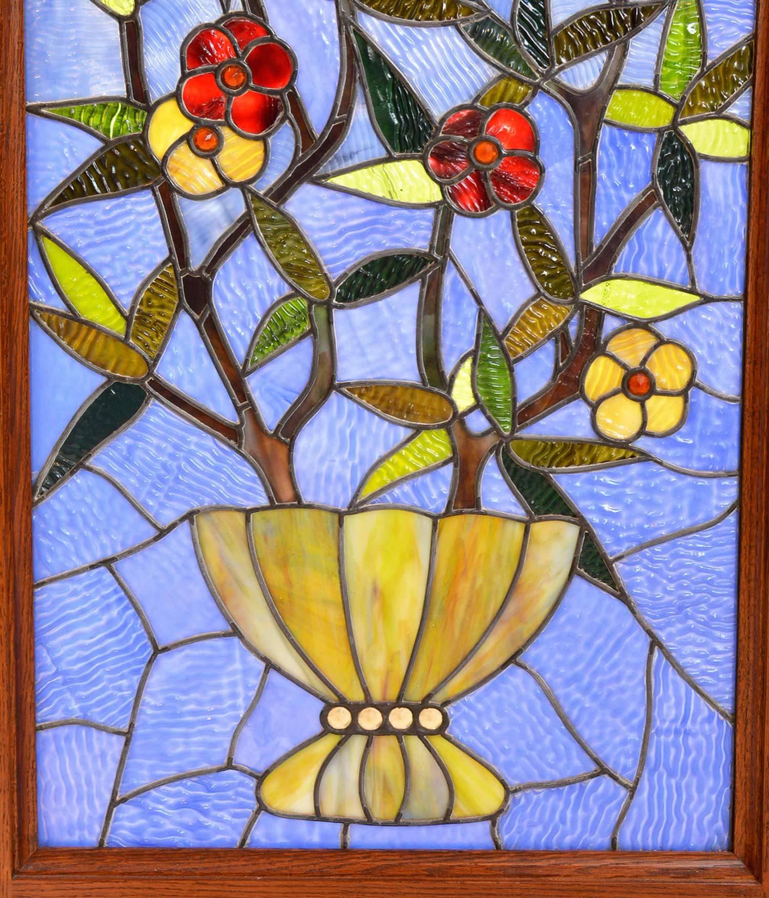Beautiful stained glass vase and stained glass floral bouquet window from the Aesthetic movement. Great play of colors with rich textured glass background. In excellent condition, free of cracks or breaks.