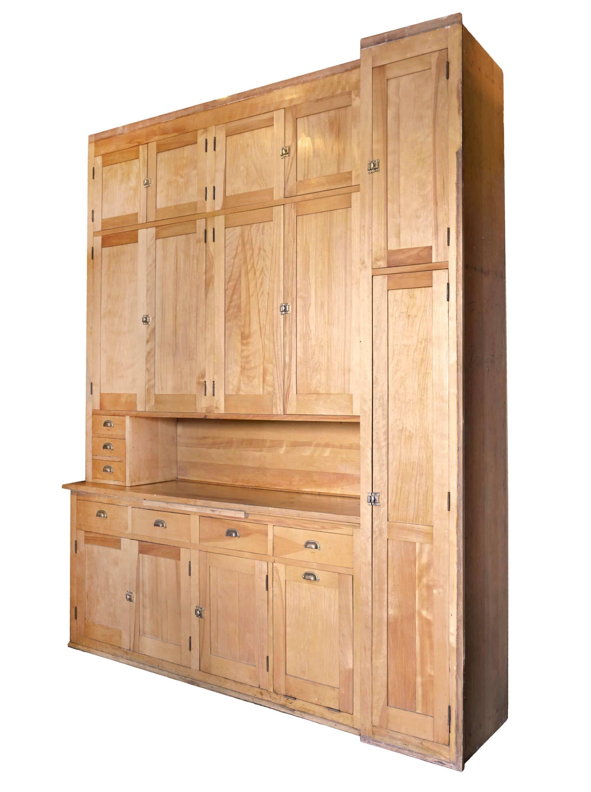 This maple kitchen cabinet has been well cared for, for the last 100 years. It has its beautiful original finish that features the lovely warm figure of maple, bead board back and original brass hardware. Great for storage with multiple drawers and