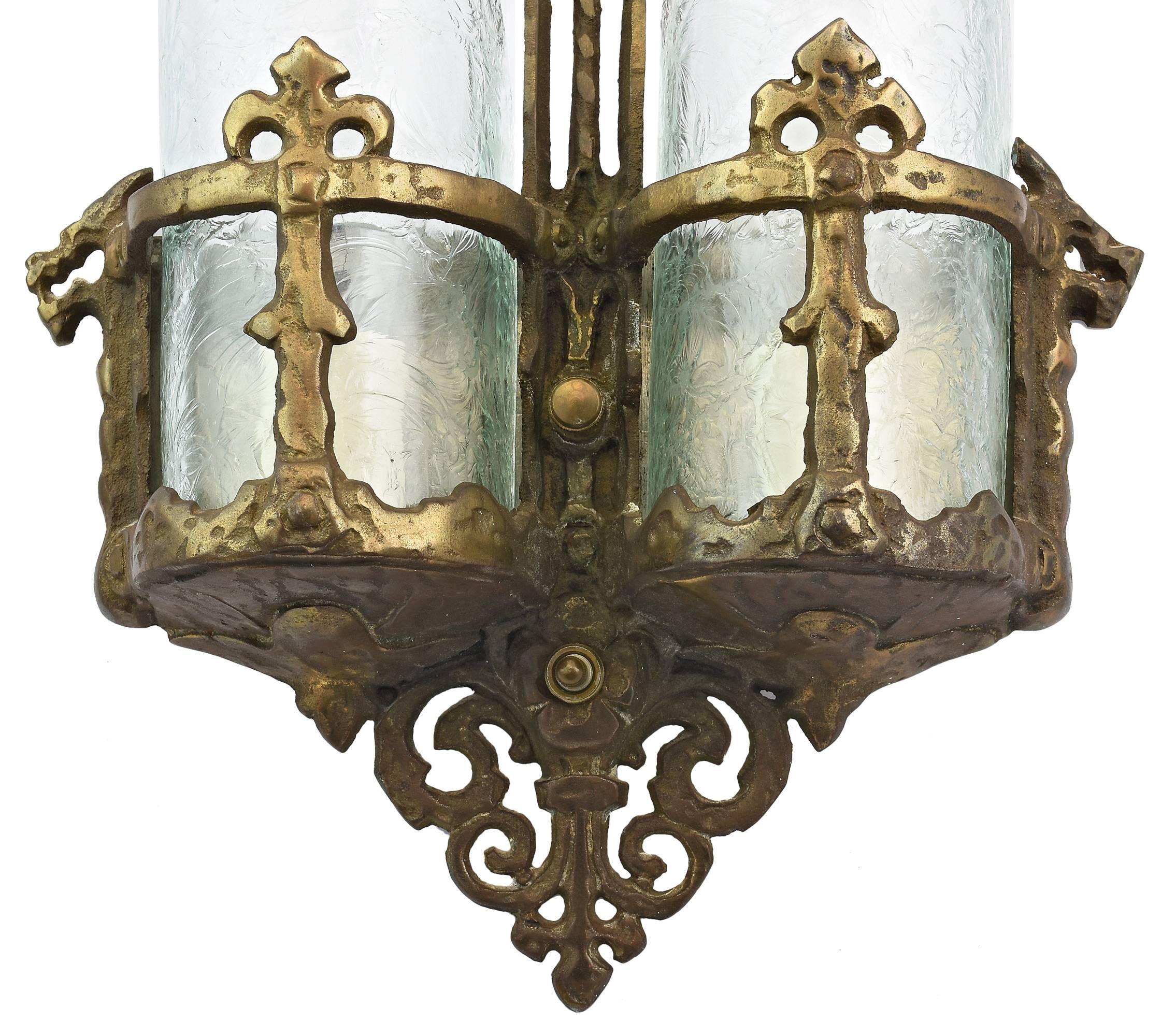 Great pair of unique scones with a decorative hammered finish and fleur-de-lis, dragon, and scroll details, with curved glue chip glass slipper shades and rich original finish. This listing is for the pair. 

We find that early antique lighting