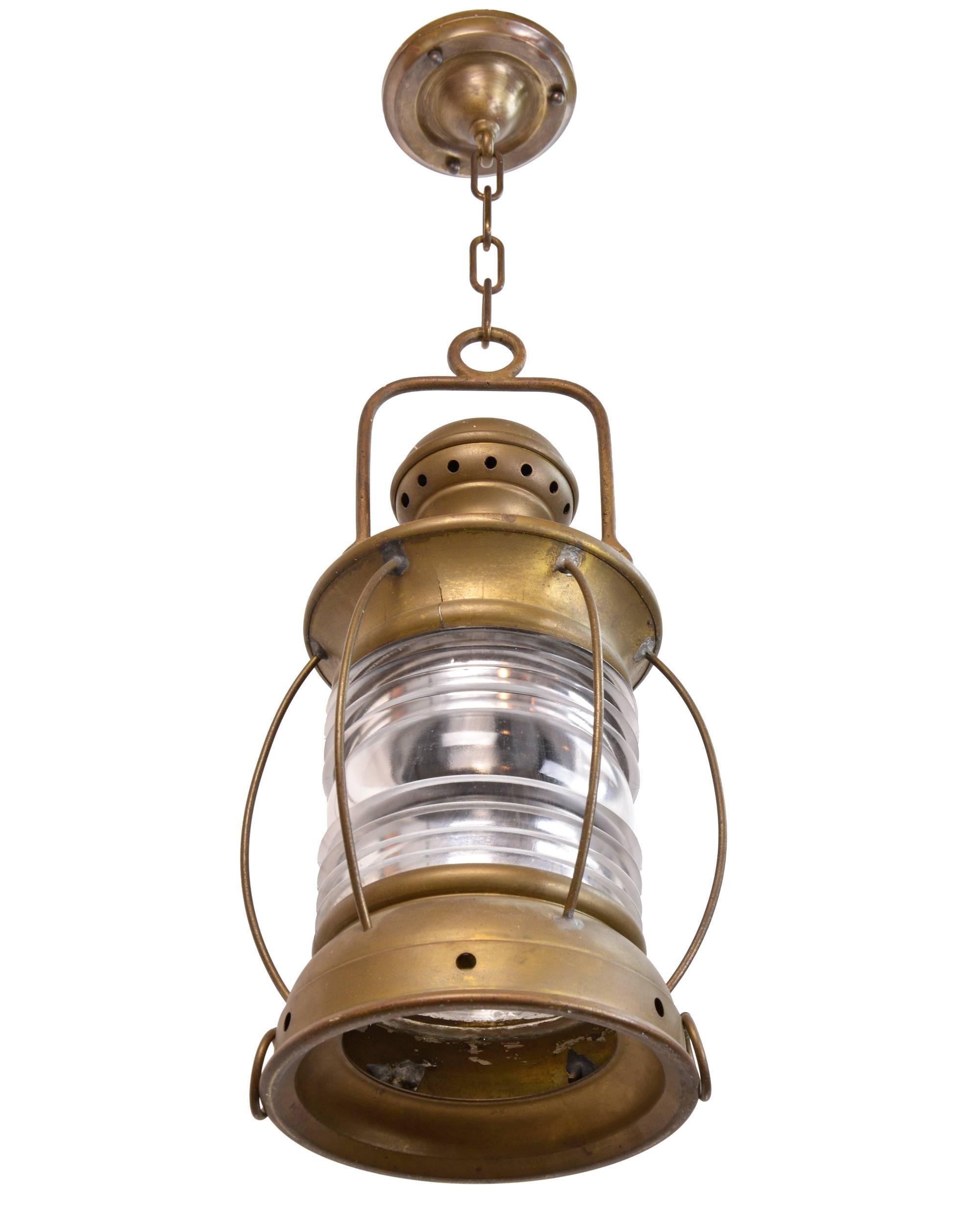 The Perkins Marine Lamp Corp. of Brooklyn, NY have been known for quality nautical lighting for decades and are now know as Perko. Here, are a pair of early pendants. Perfect patina in brass, each has its original ribbed glass and are a great size