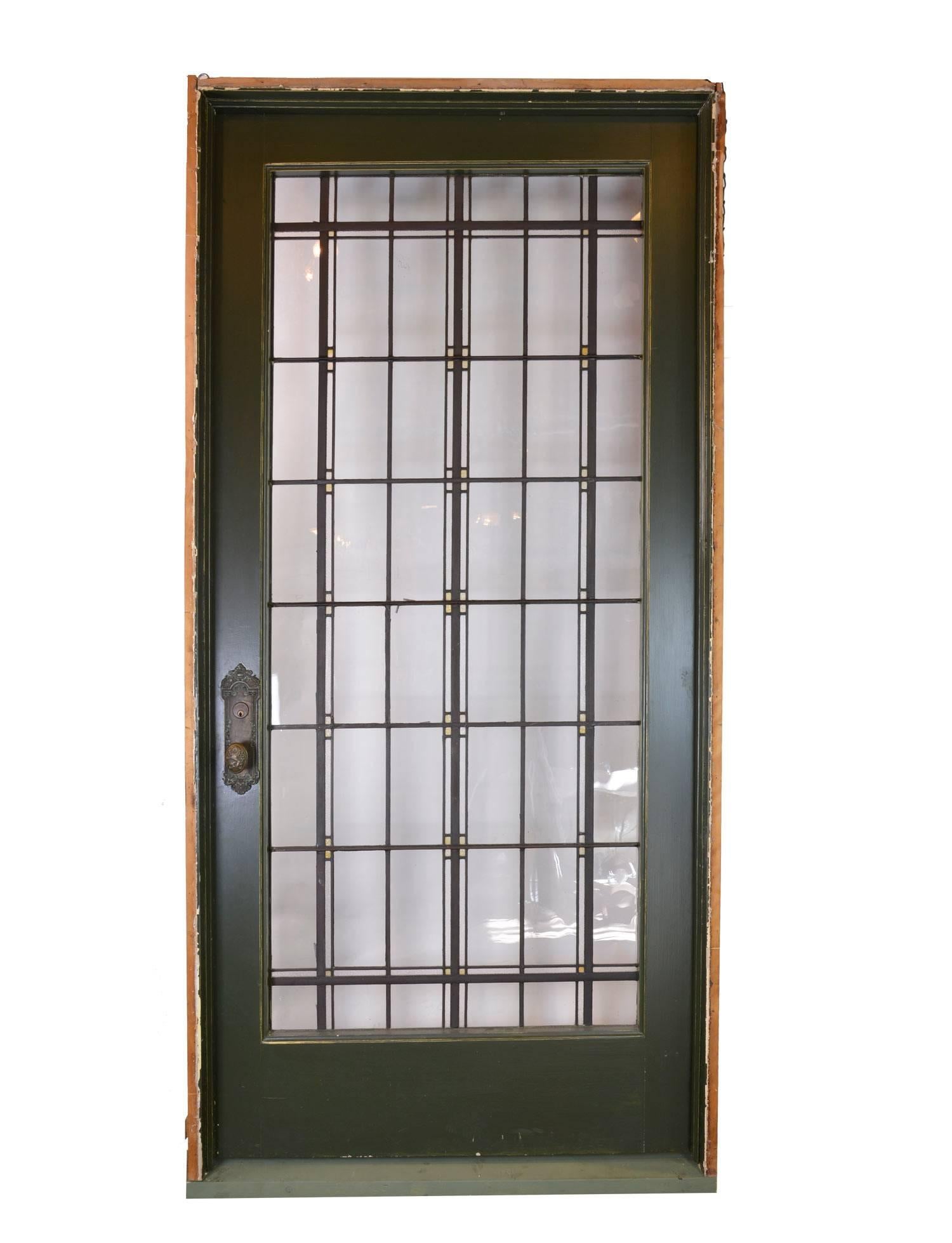 This regal glass door unit with stained glass details was recovered from a sizable Midwest home in a historic district. The door is painted a dark forest green over oak, and the glass is in pristine condition. Included is the original jamb and a