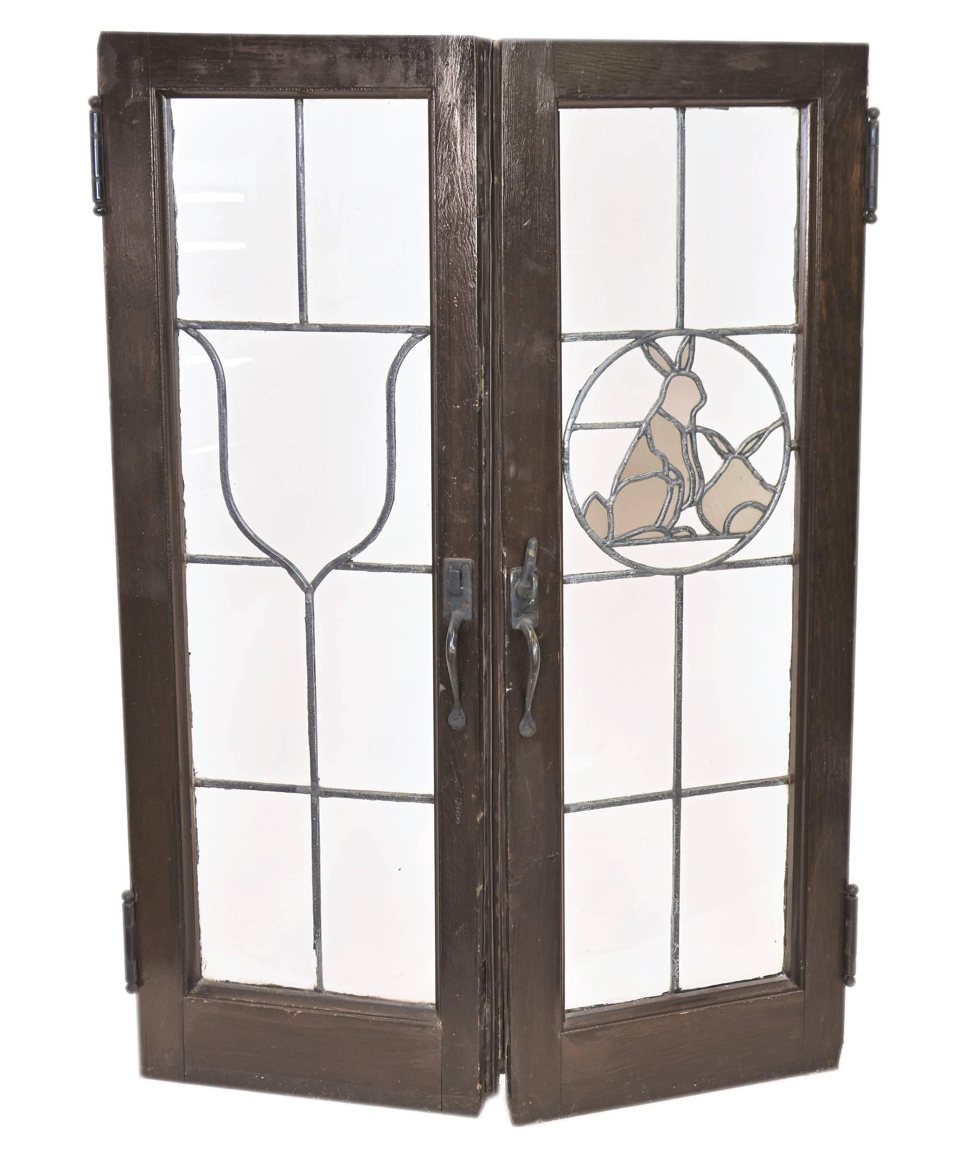 Recovered from a sizable home in a historic Minneapolis neighborhood, this set of eight French windows feature a wonderful series decorative emblems, including shield, rabbits, fish and geese. Paired together three sets includes one shield and one