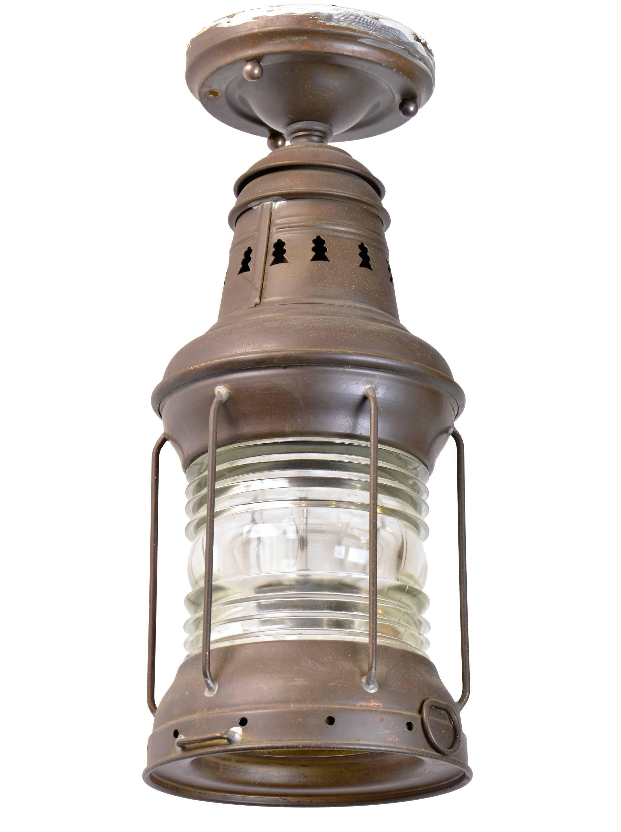 An original flush mount brass ship lantern with ribbed glass, manufactured by Russell & Stoll, circa 1940. This lantern is full of character, the perfect Industrial fixture to light a room!

We find that early antique lighting was designed as