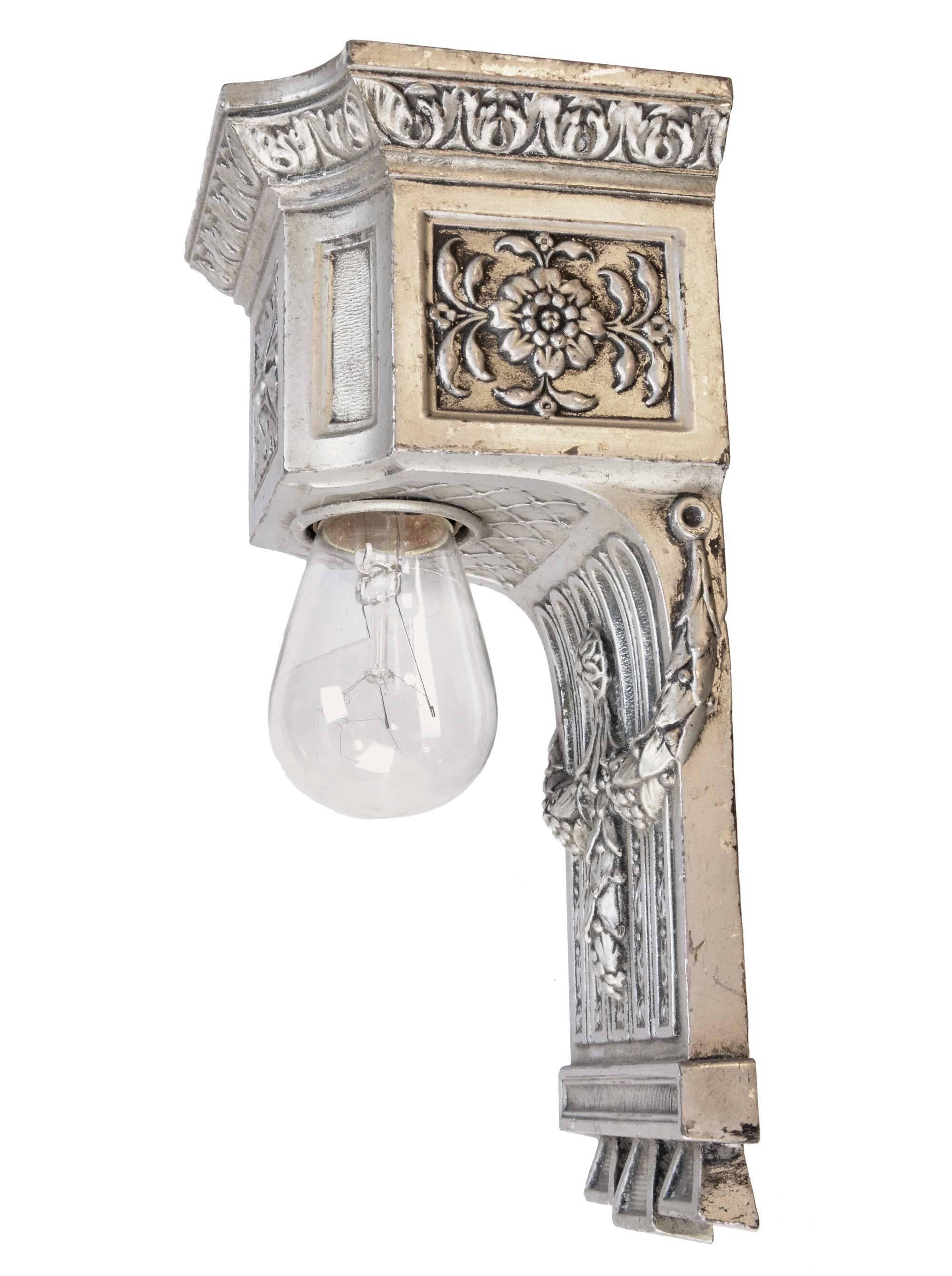 This fabulous pair of early American lighting is made from cast brass plated in silver. Made circa 1915 in the Beaux Arts style, there is beautiful decoration throughout these sconces, including fanciful ropes and swags that reference Classical