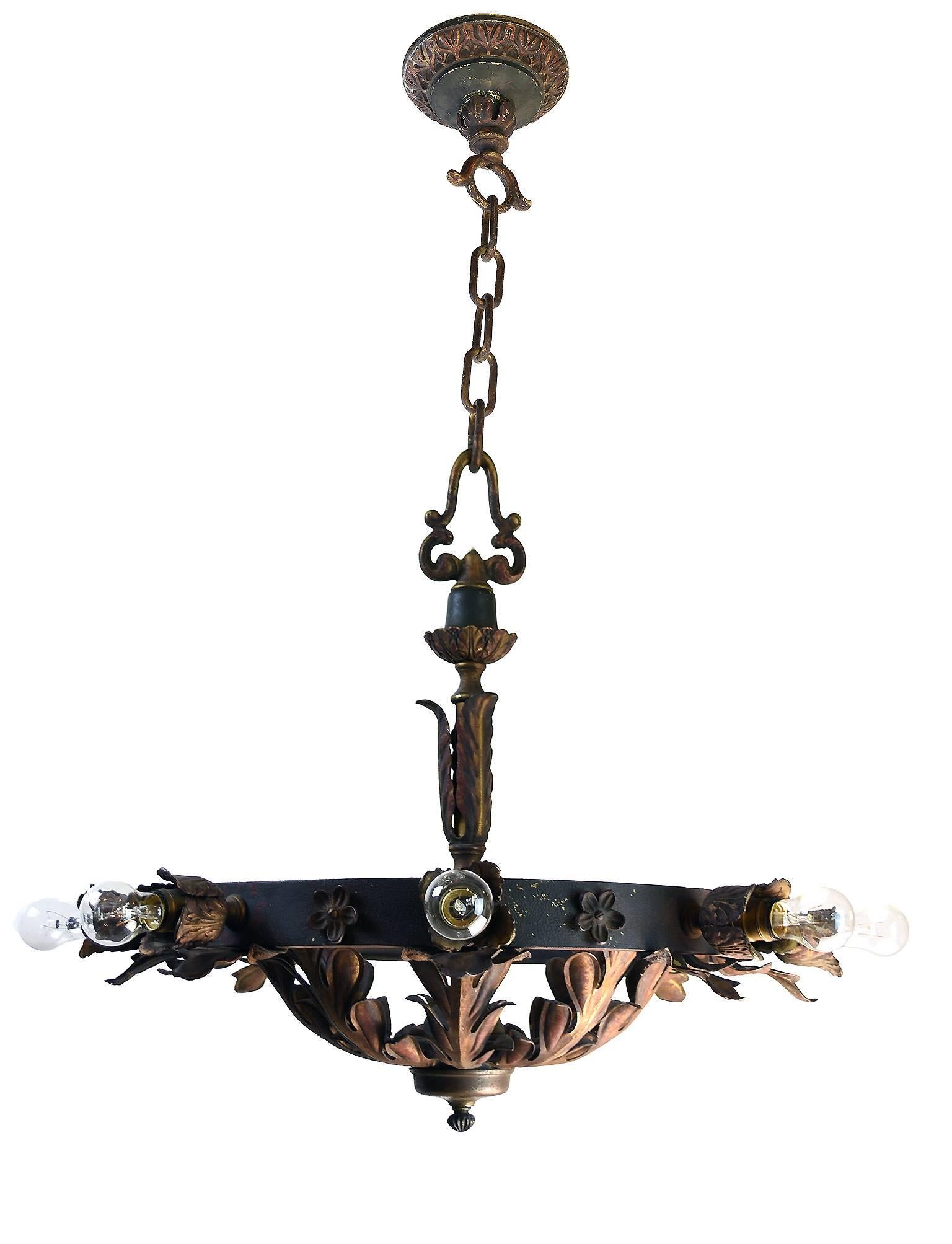 This great, over-sized fixture from the 1920s includes cast brass and iron organic ornamentation that creates wonderful contrast in color and texture. The fixture has 8 standard Edison sockets and is originally from a Masonic Lodge in Southern