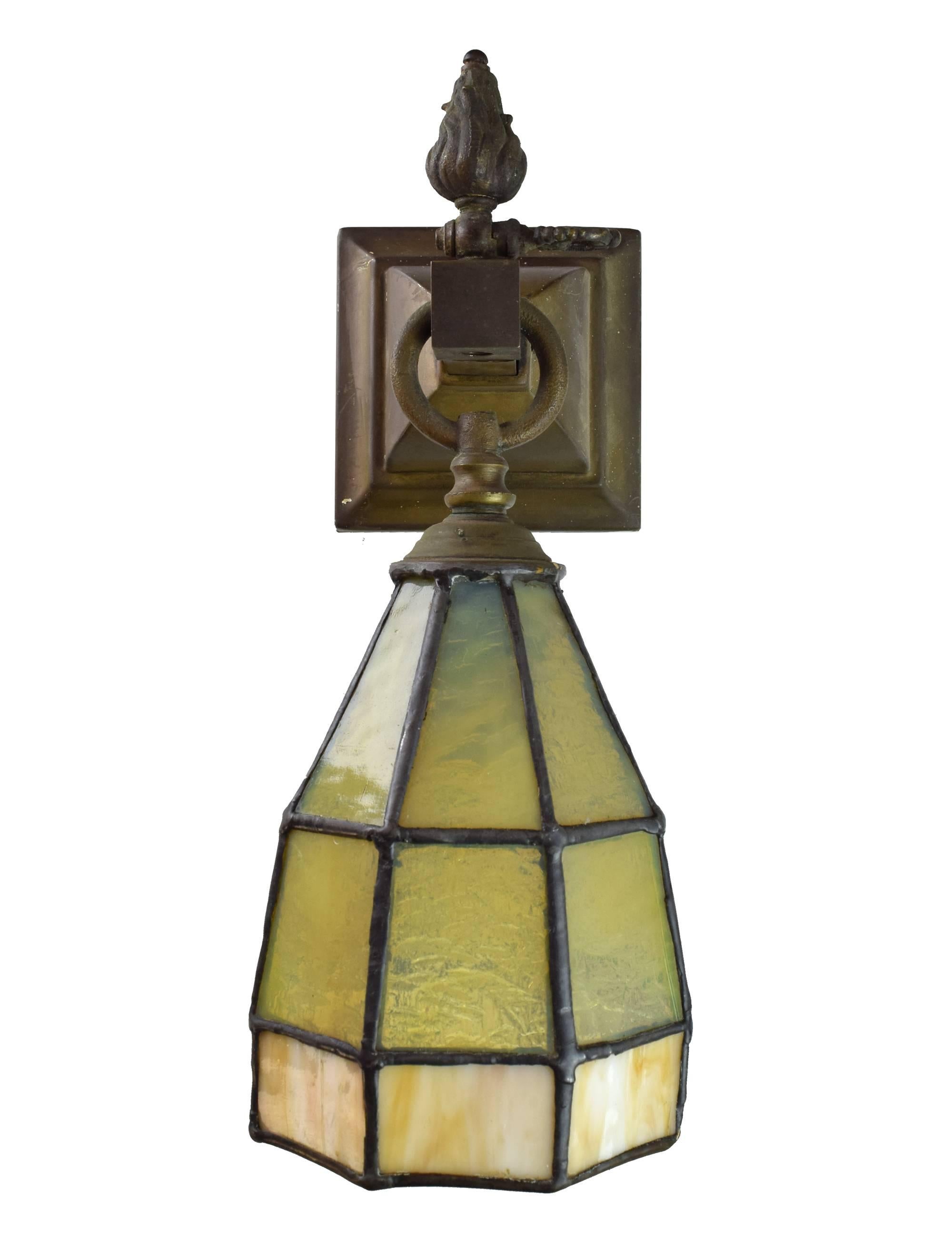 A fabulous pair of original Arts and Crafts-style sconces with a stained glass shade and a lovely original brass patina. This early pair has both gas/electric components. Matching chandelier also available. 

Measures: 12.5