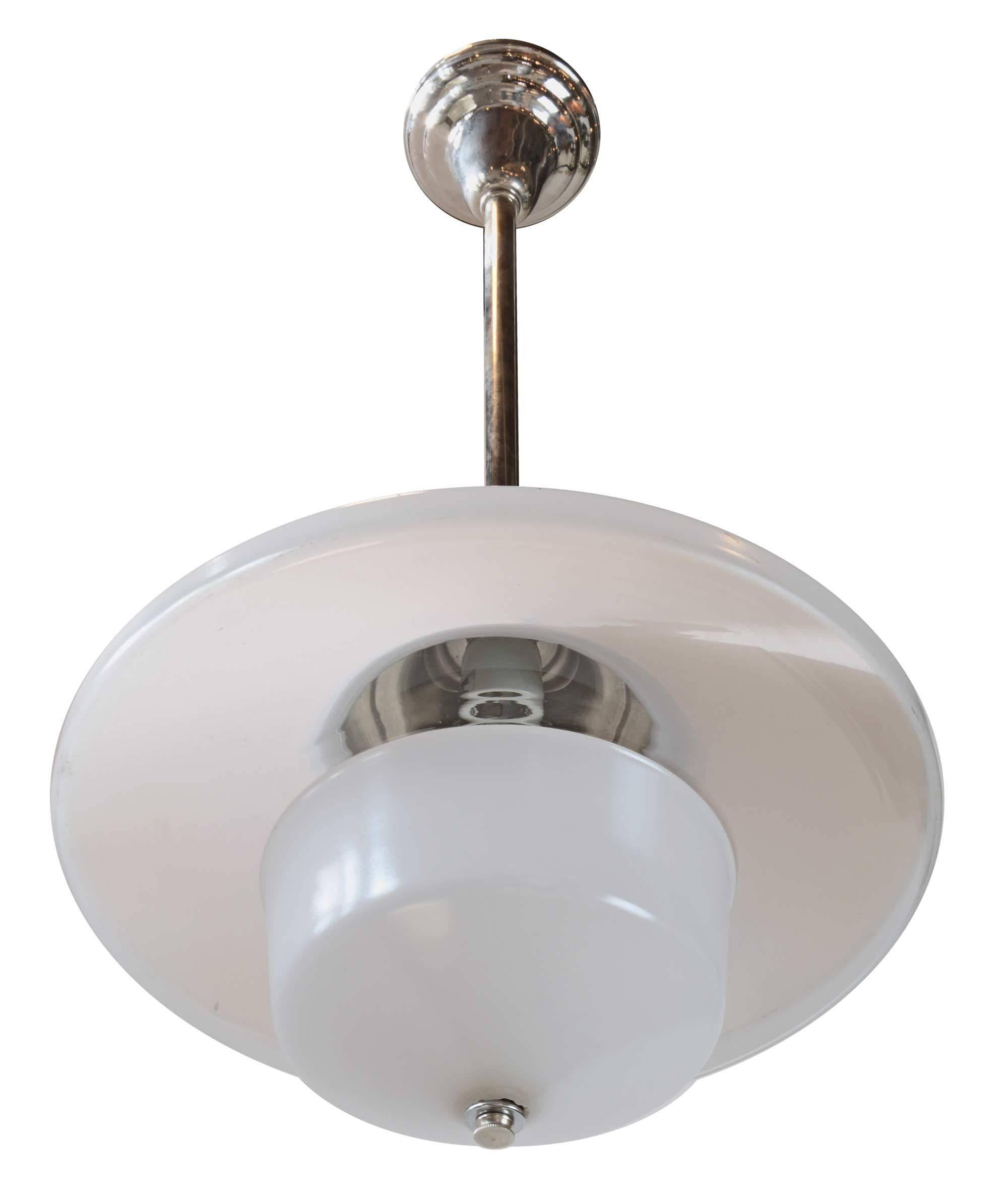 A new chrome pendant paired with a unique early American clear and white glass shade. This Industrial light fixture made circa 1909 sheds a wonderful quality of light. 

Measures: 14" diameter x 29" tall (adjustable).

We find that early