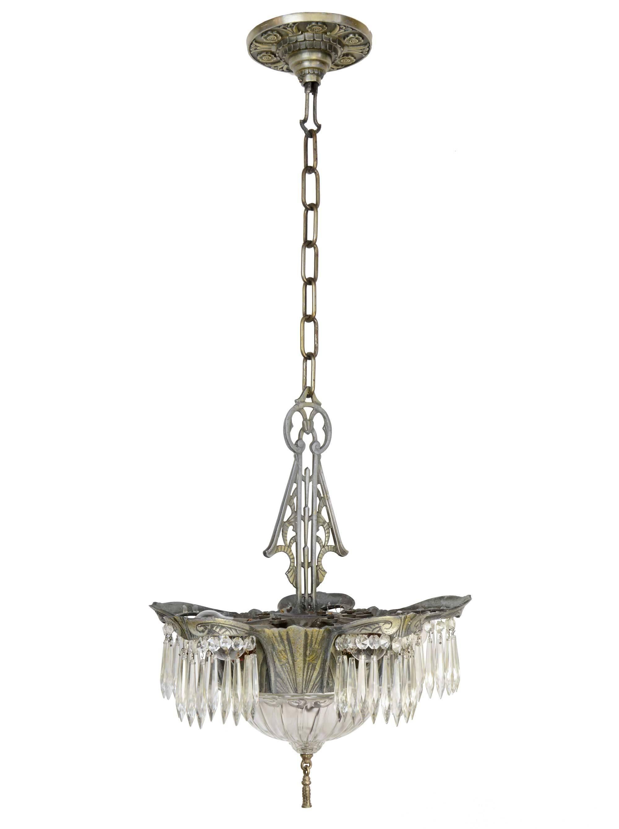 This silver Art Deco chandelier made by Lincoln Lighting Company has five lights surrounding the cut-glass bowl, each adorned with crystals. The fixture includes the original floral canopy and decorative finial. Four matching sconces also