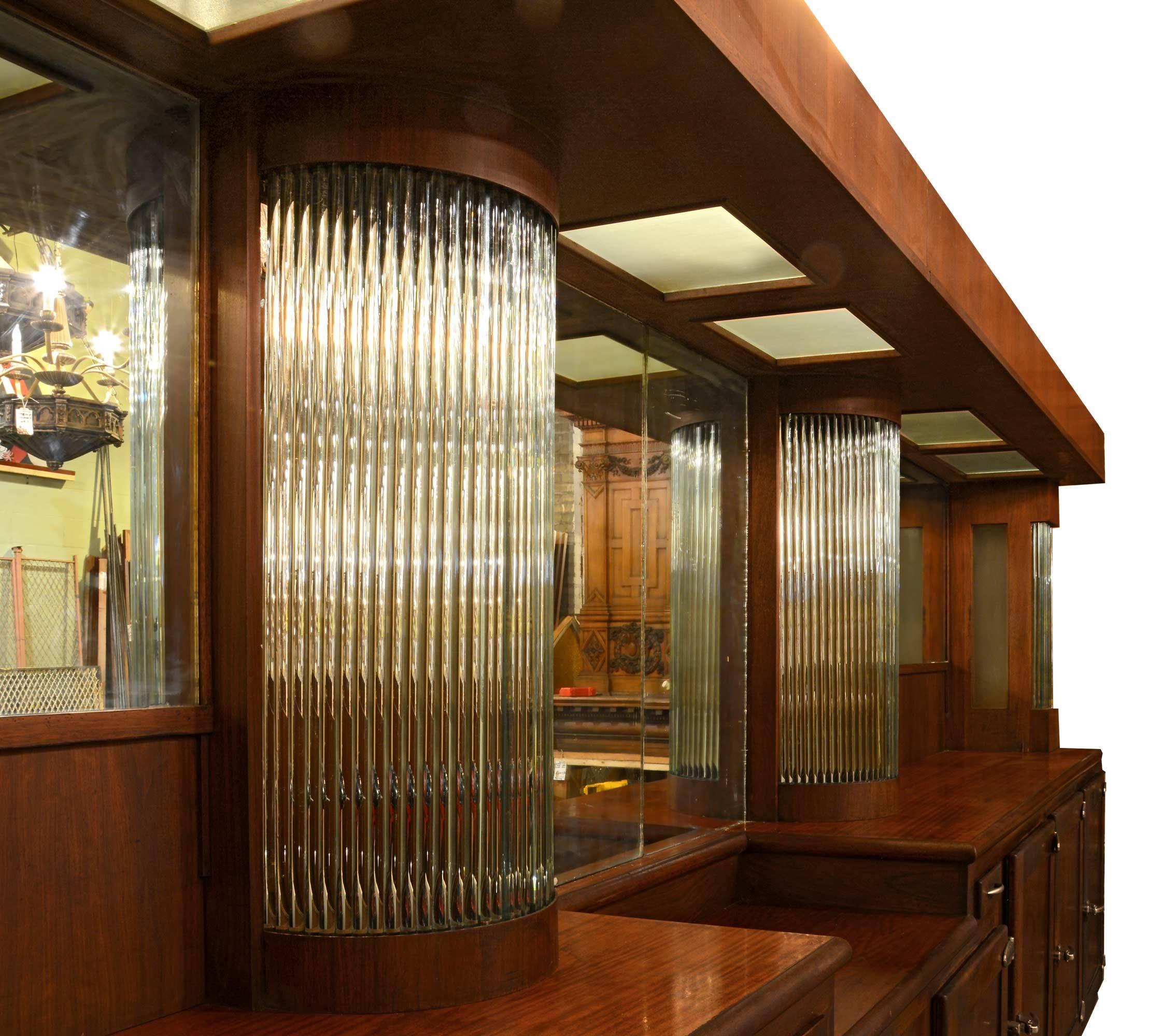 This gorgeous mahogany bar with a wraparound L-shaped counter is from an American Legion. The back bar features mirrors, plenty of storage, and rows of glass rods to diffuse light while you're slinging drinks!

Measures: Back bar: 93" tall x