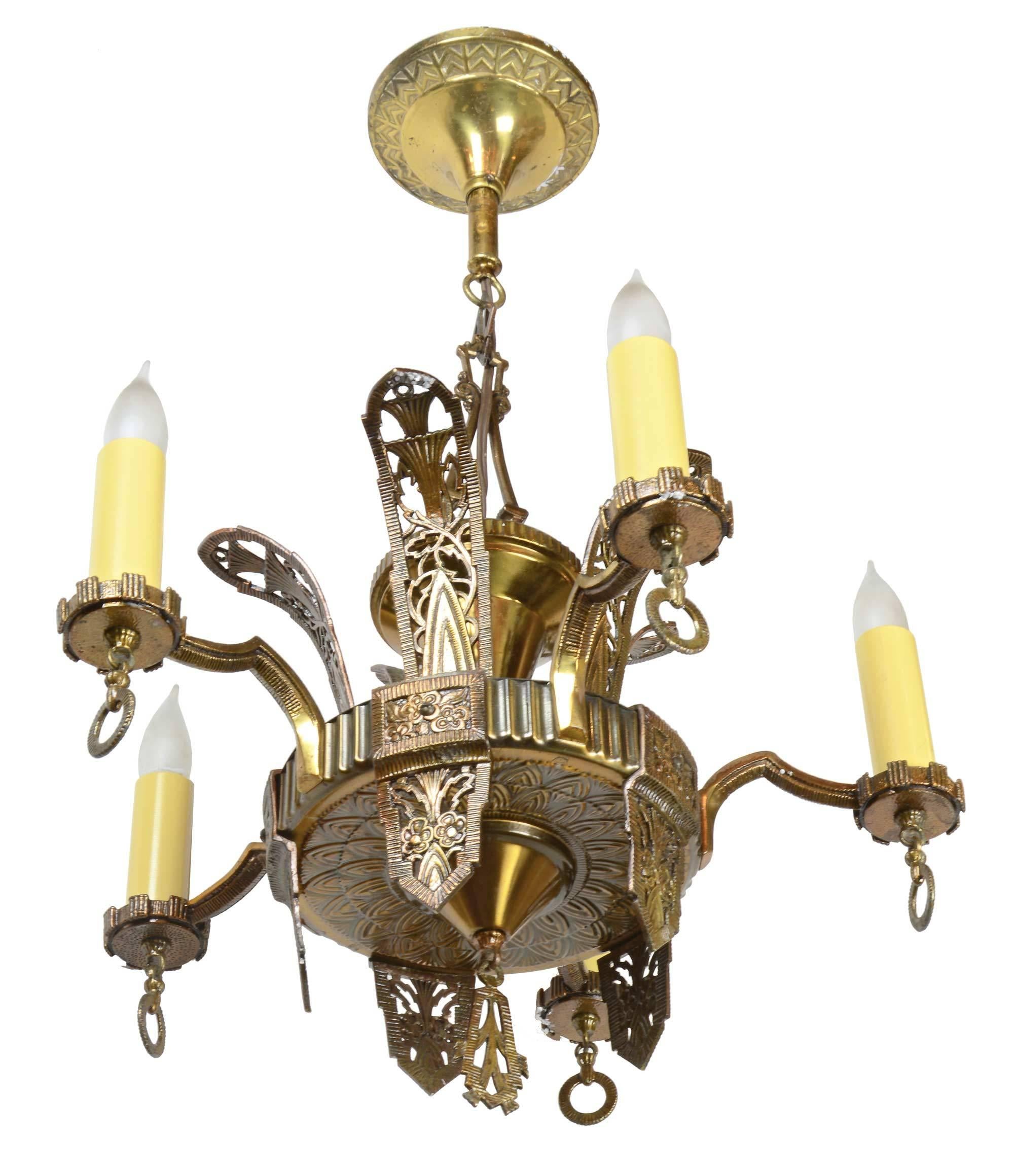 Gorgeous brass five-arm chandelier with Art Deco detailing throughout. 

Chandelier has five medium sockets and is re-wired and ready to hang, following UL standards.