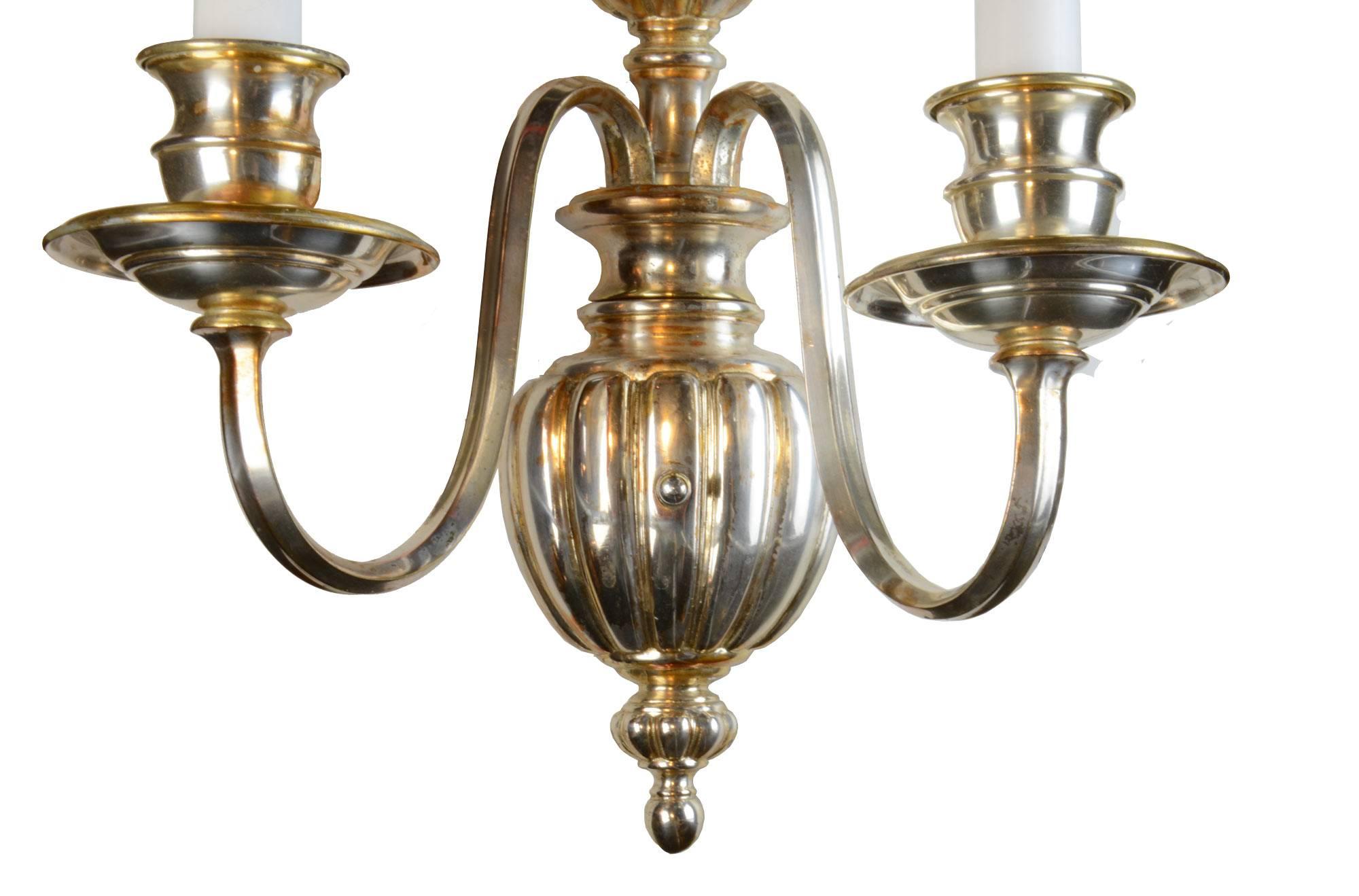 Elegant silver plated two-arm sconce made in the Sheffield style. Features fluted details and a timeless composition.

We find that early antique lighting fixtures were designed as objects of art and we treat each one with careful attention to