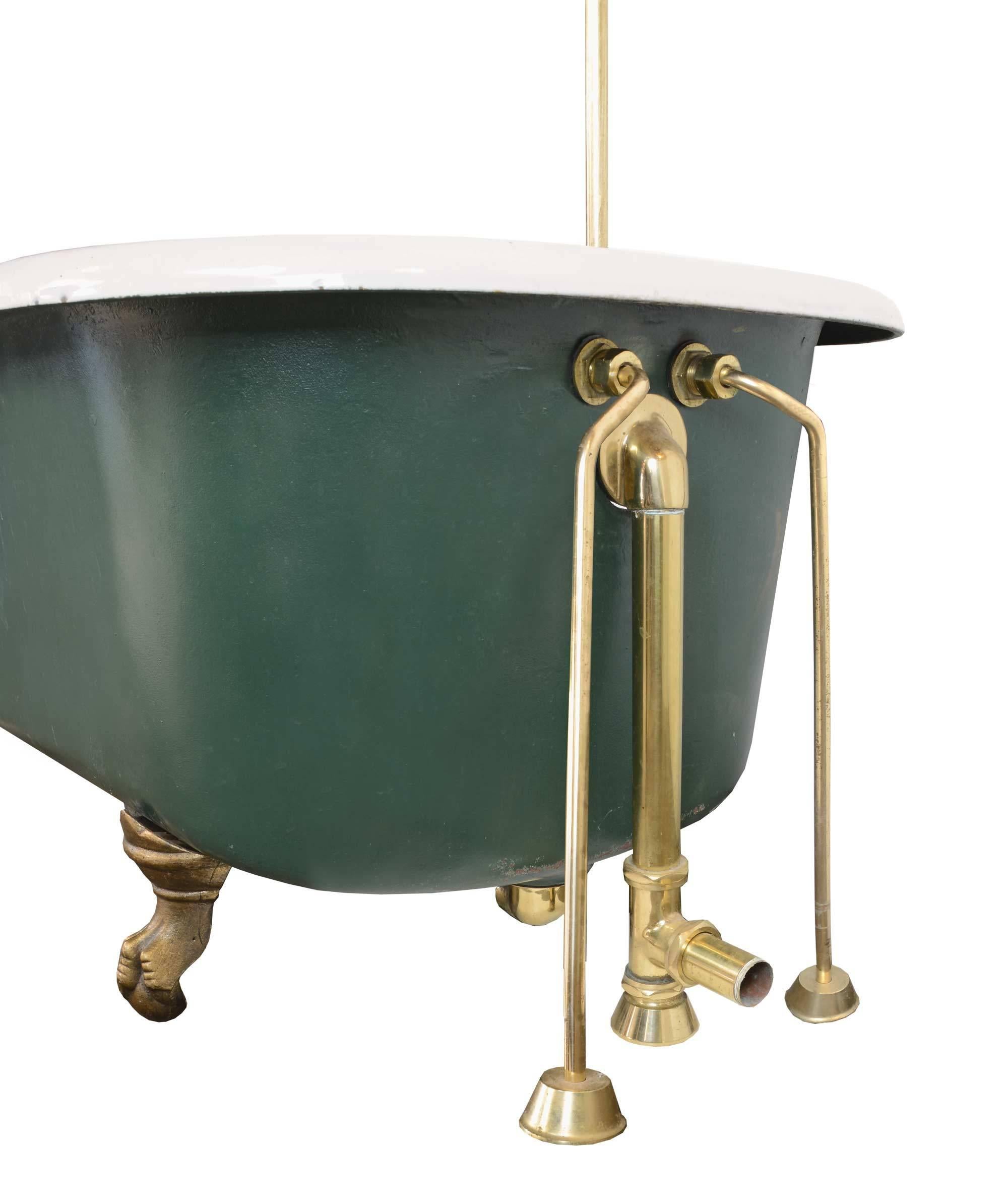Five foot forest green cast iron bathtub with decorative claw feet and brass-plated hardware, including original faucet and handles, soap dish, and shower curtain rod with ceiling mount. 

Measurements:
Overall: 100