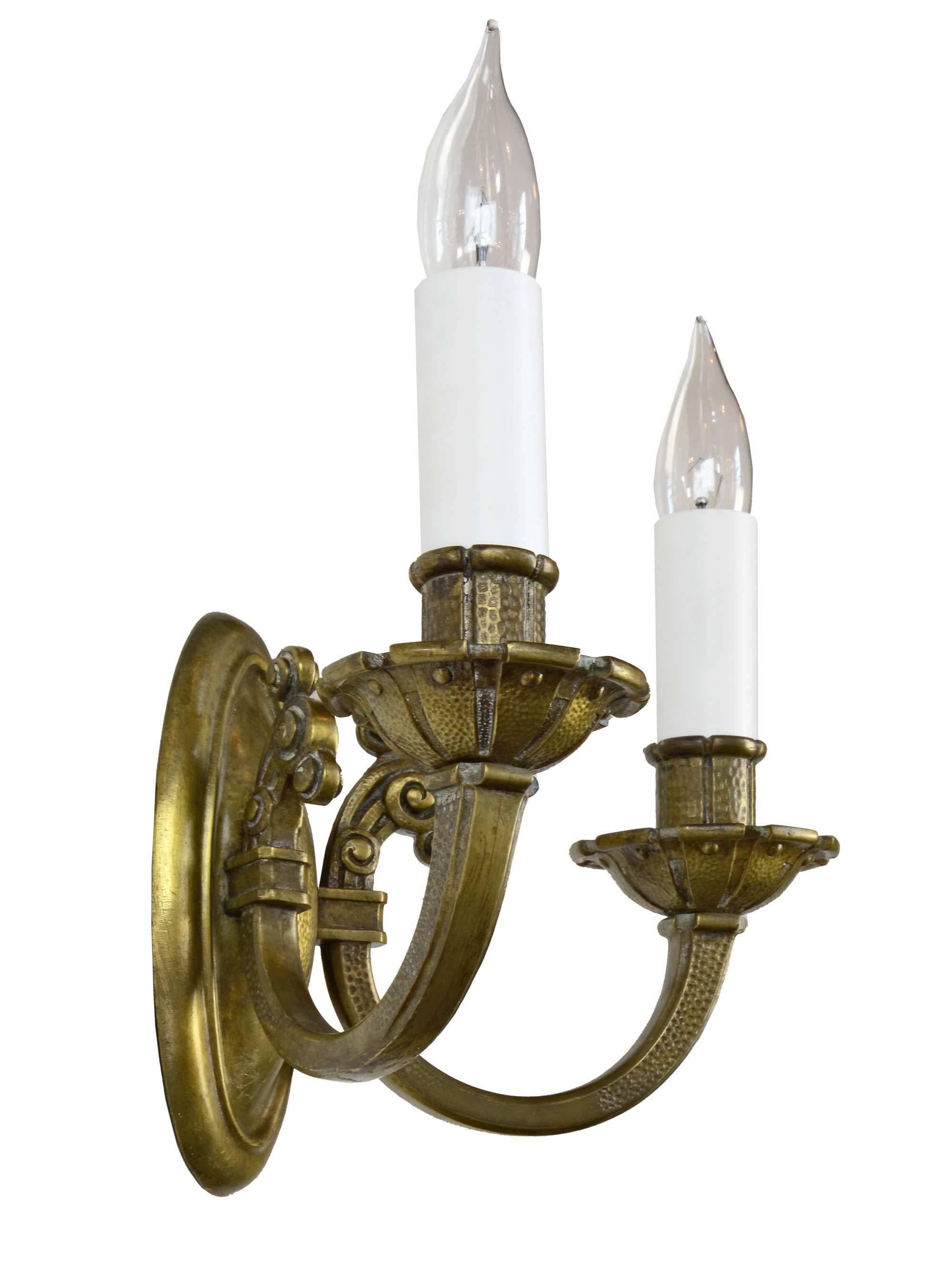 This high-quality sconce has a wonderful polished brass finish and great details in the hammered finish, scrolled arms and crenulated bobeches.

We find that early antique lighting was designed as objects of art and we treat each fixture with