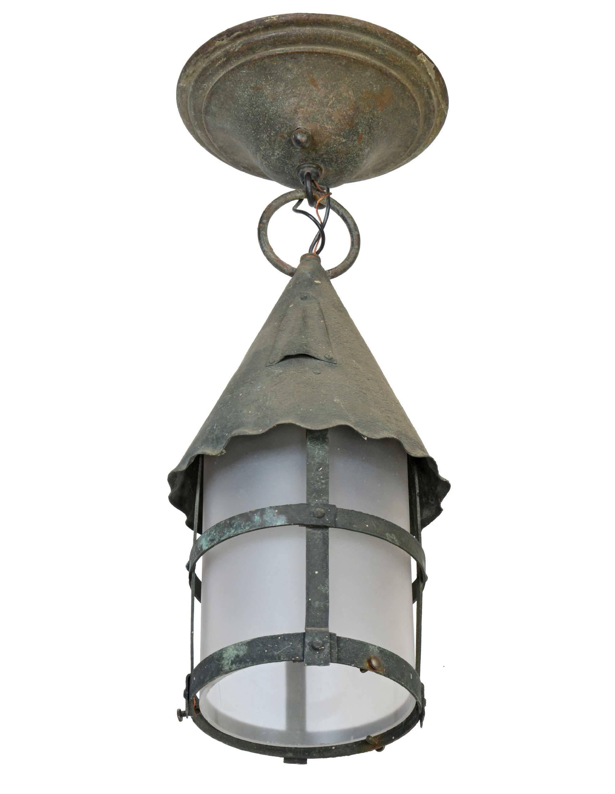 This exterior copper lantern features Arts and Crafts details and has a white glass tube insert.

Finish: Original patina.
Single medium socket.
Measures: 17
