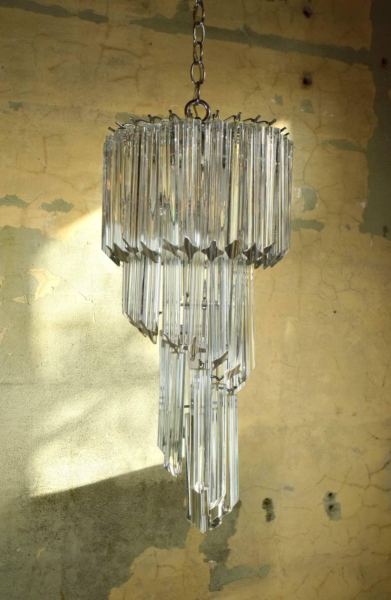 Fifty heavy Murano glass crystals spiral downwards on this stunning chandelier from esteemed manufacturer, Venini.

circa 1960
Condition: Excellent
Finish: Original
Country of origin: USA
Four candelabra sockets

Measurements: 12
