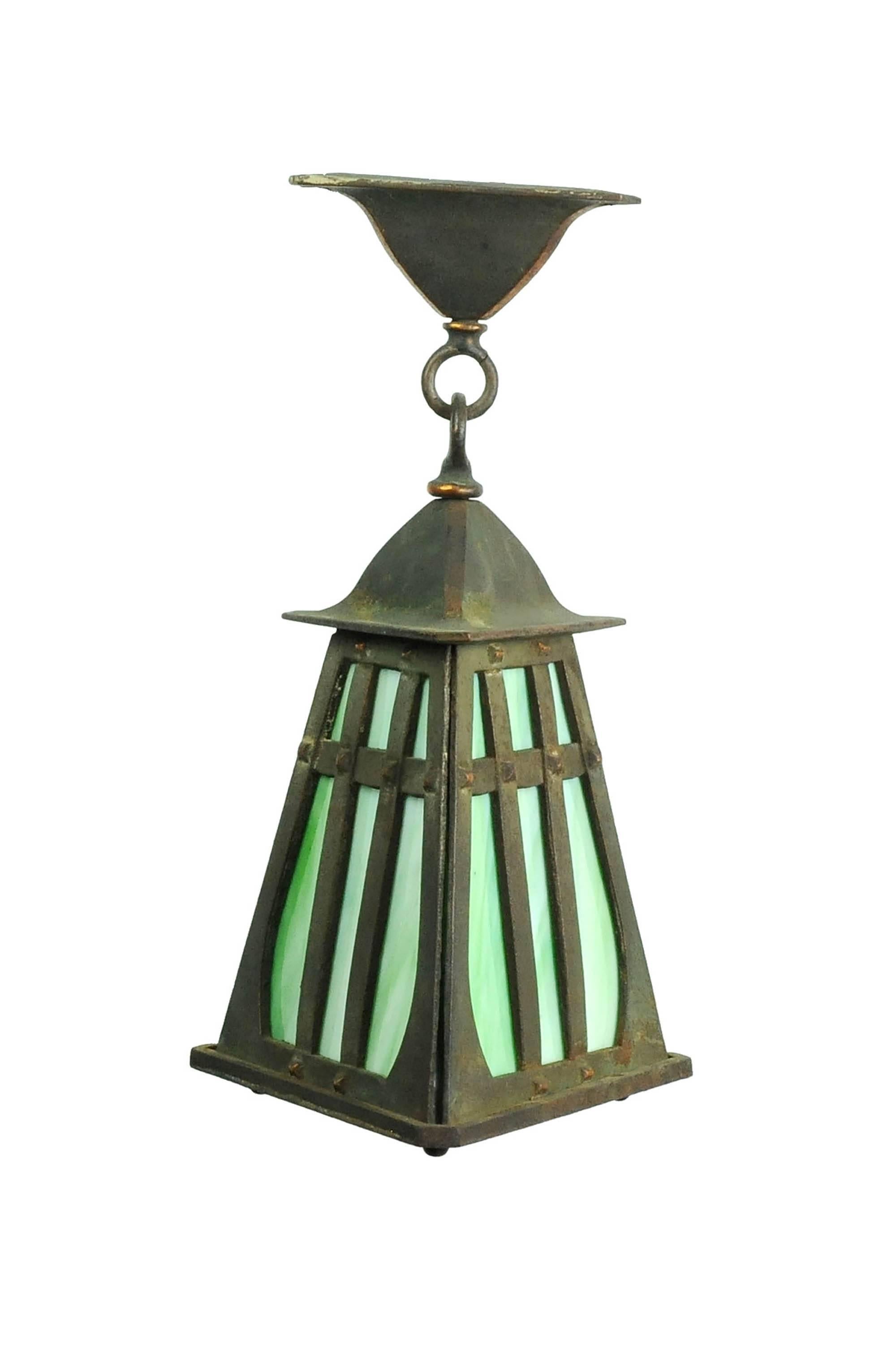 Classic craftsman pendant with beautifully oxidized copper plating and green slag glass. Perfect for a porch, kitchen, or other smaller space.

Finish: Original (copper-plated iron)
one medium socket

We find that early antique lighting was
