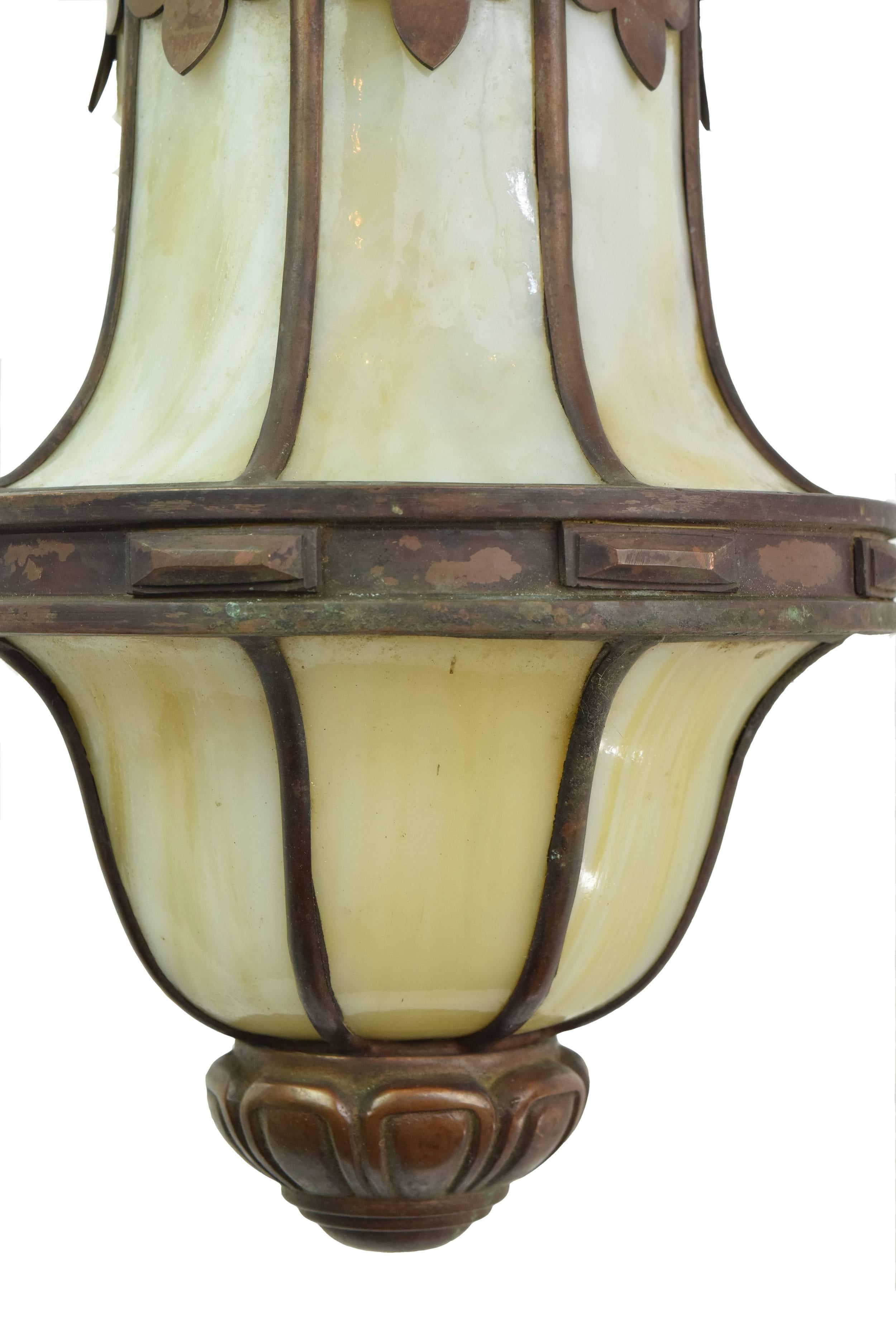 A beautiful green glass lantern with bronze metal work will become an impressive accent piece in your home. This lantern would be perfect in a foyer or formal dining room!

Finish: Original
One medium socket

We find that early antique lighting
