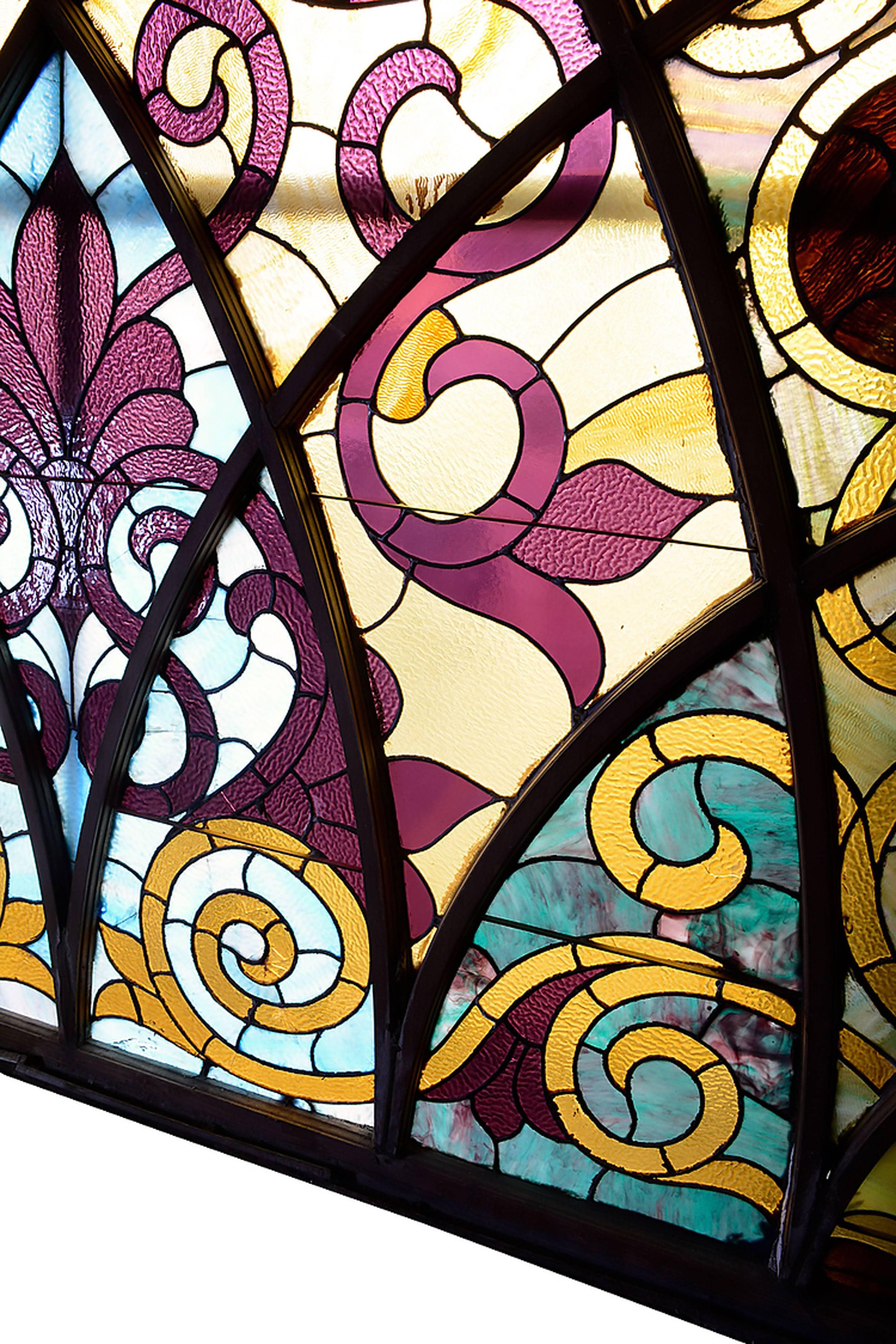 Large-scale colorful arched Victorian leaded glass window with slag, stained and rippled glass detail. A stunning masterpiece!