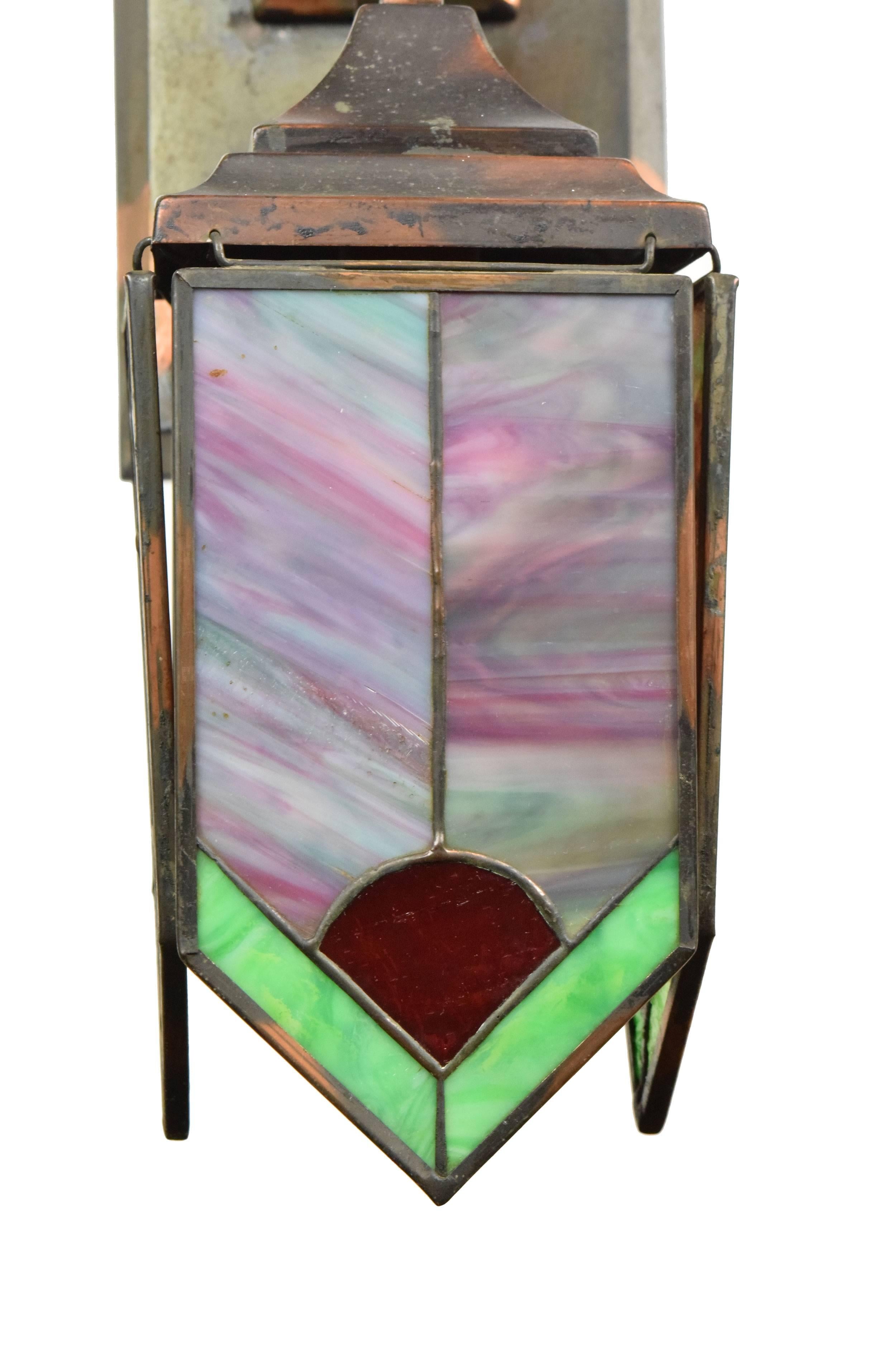 This oversized Mission sconce features a rich gilt and satin finish and unique hanging stained glass panels that add a delicate touch to this masculine fixture. Lovely when lit or off - a true piece of decorative art.

We find that early antique