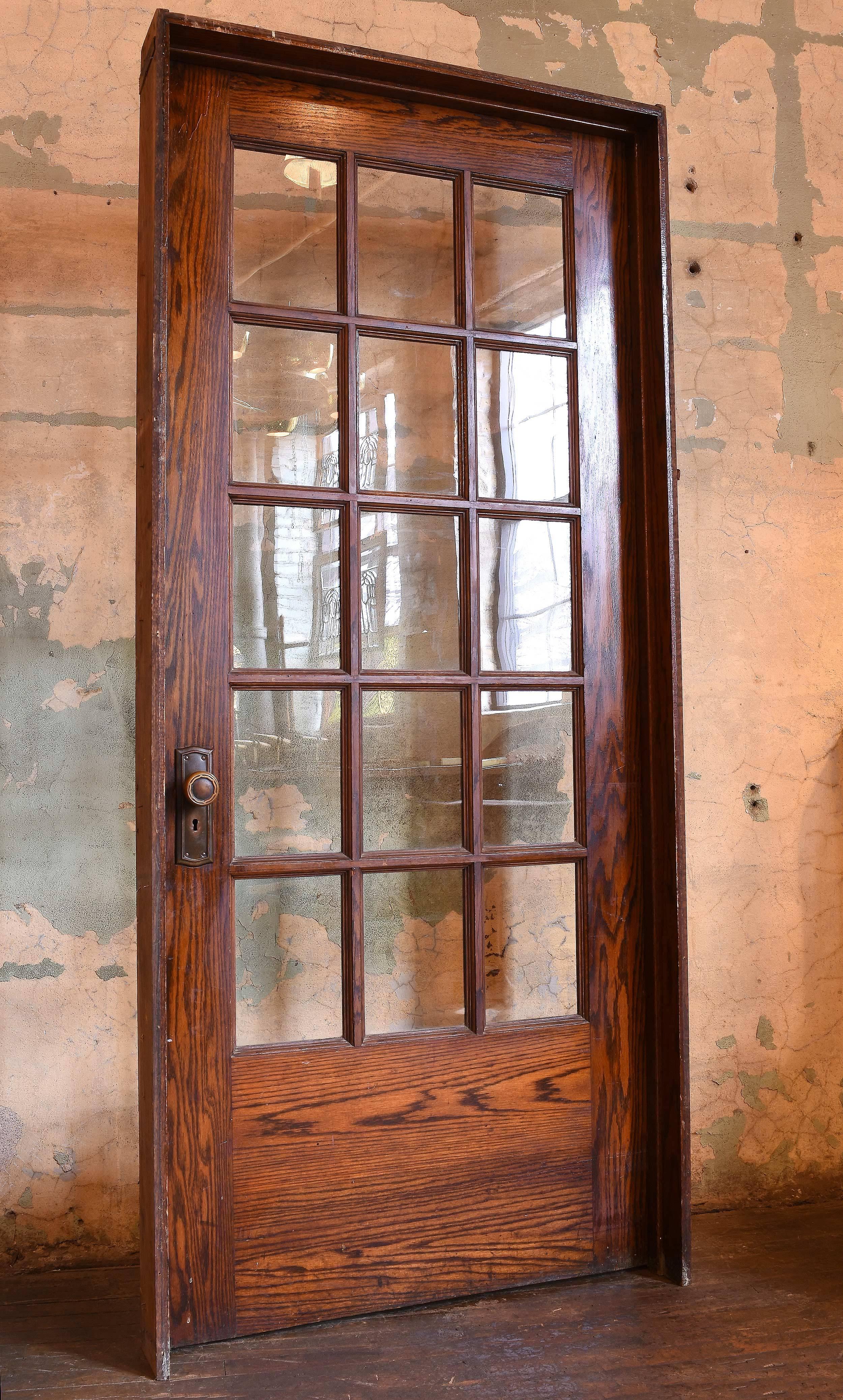 These divided fifteen-light oak doors are in good condition coming from a school house. Original finish, in their original jambs, their original ball tip hinges and original brass hardware. Will let lots of light into your room and there are 4