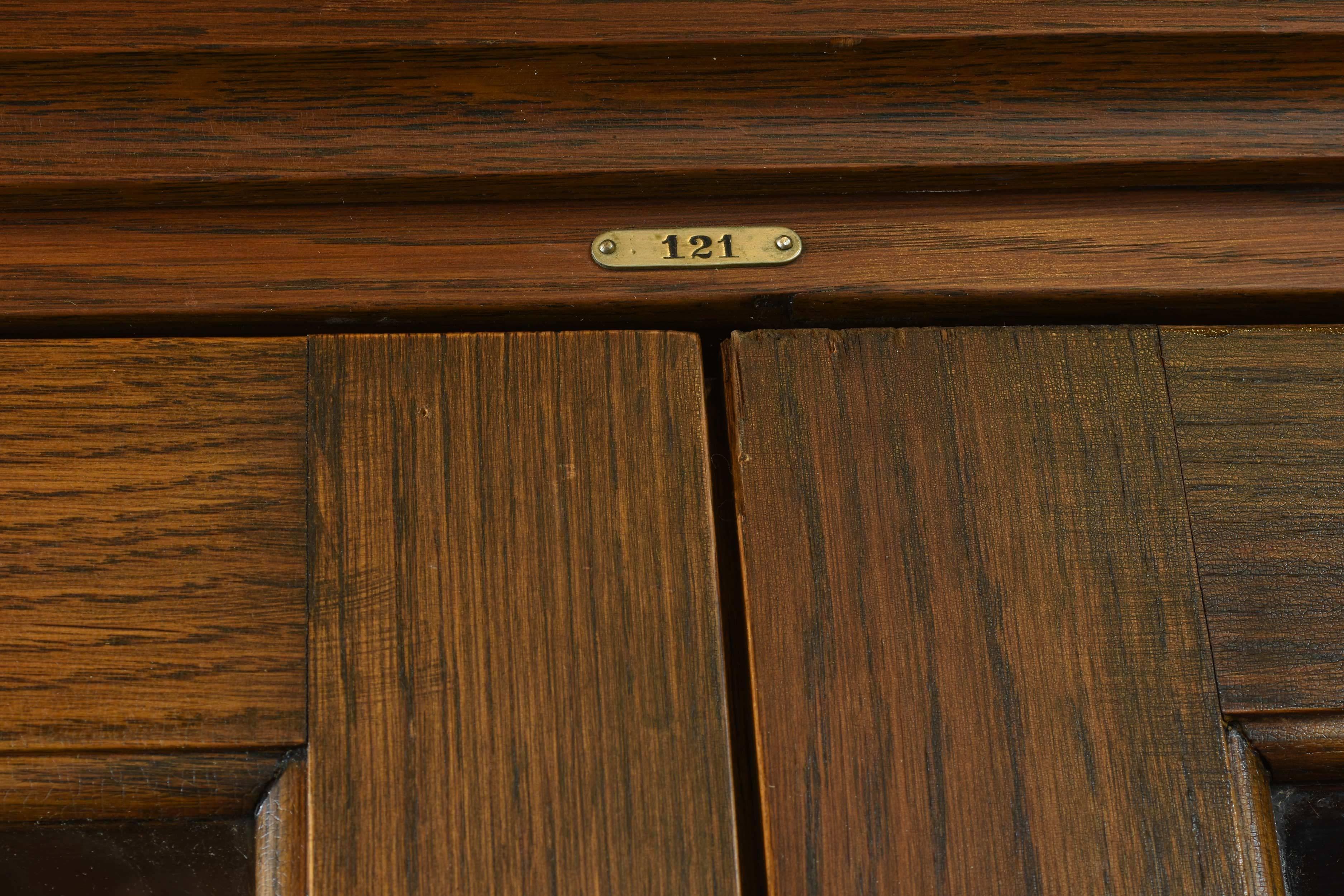This built-in stained fumed oak school room cabinet has a lot of storage space with French (19.75