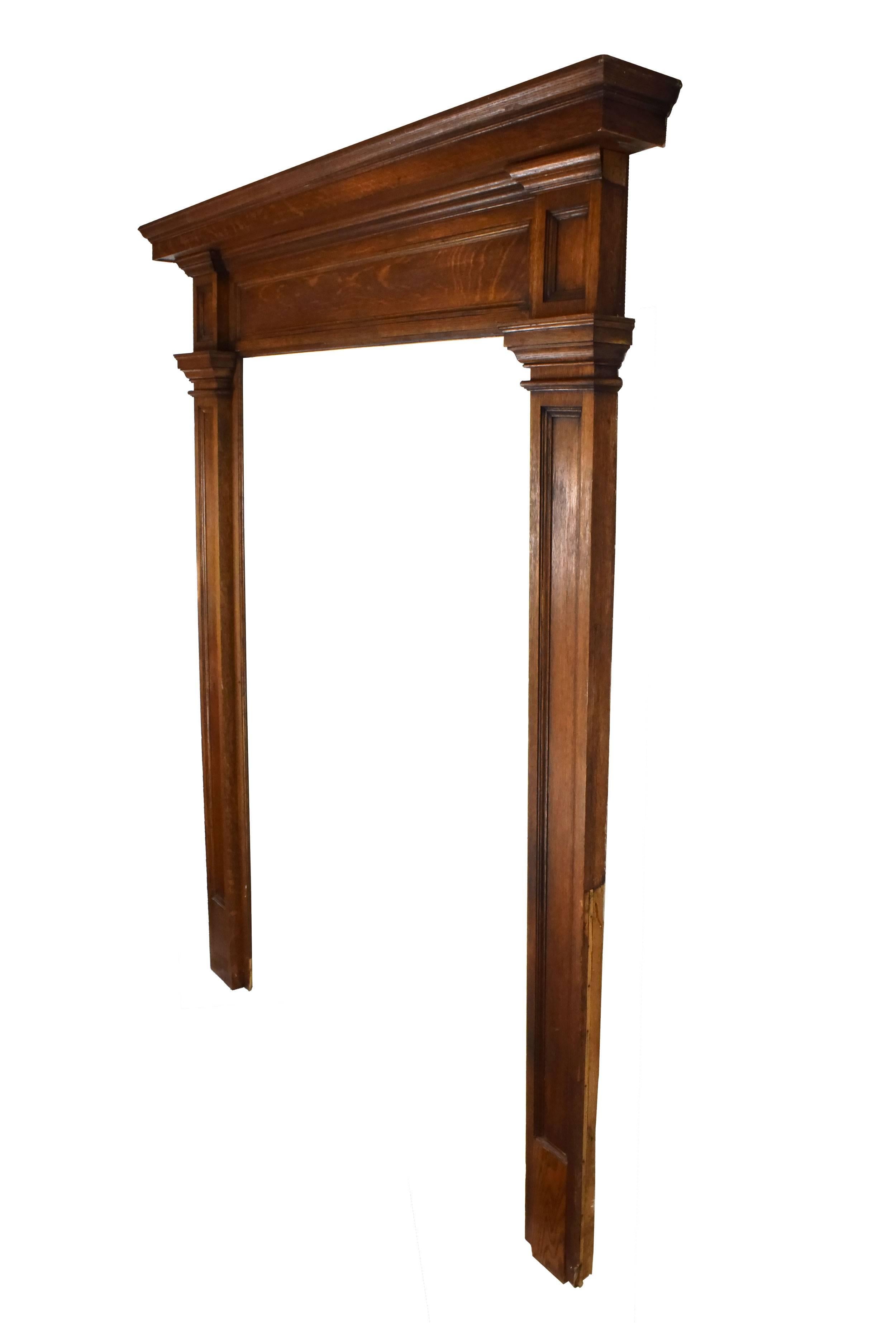 This oak walk through mantel, which stands tall at seven feet, is rich, warm and inviting. Decorative details on the header and legs add further interest to this beautiful piece. Please note that the right-hand plinth block appears to have been