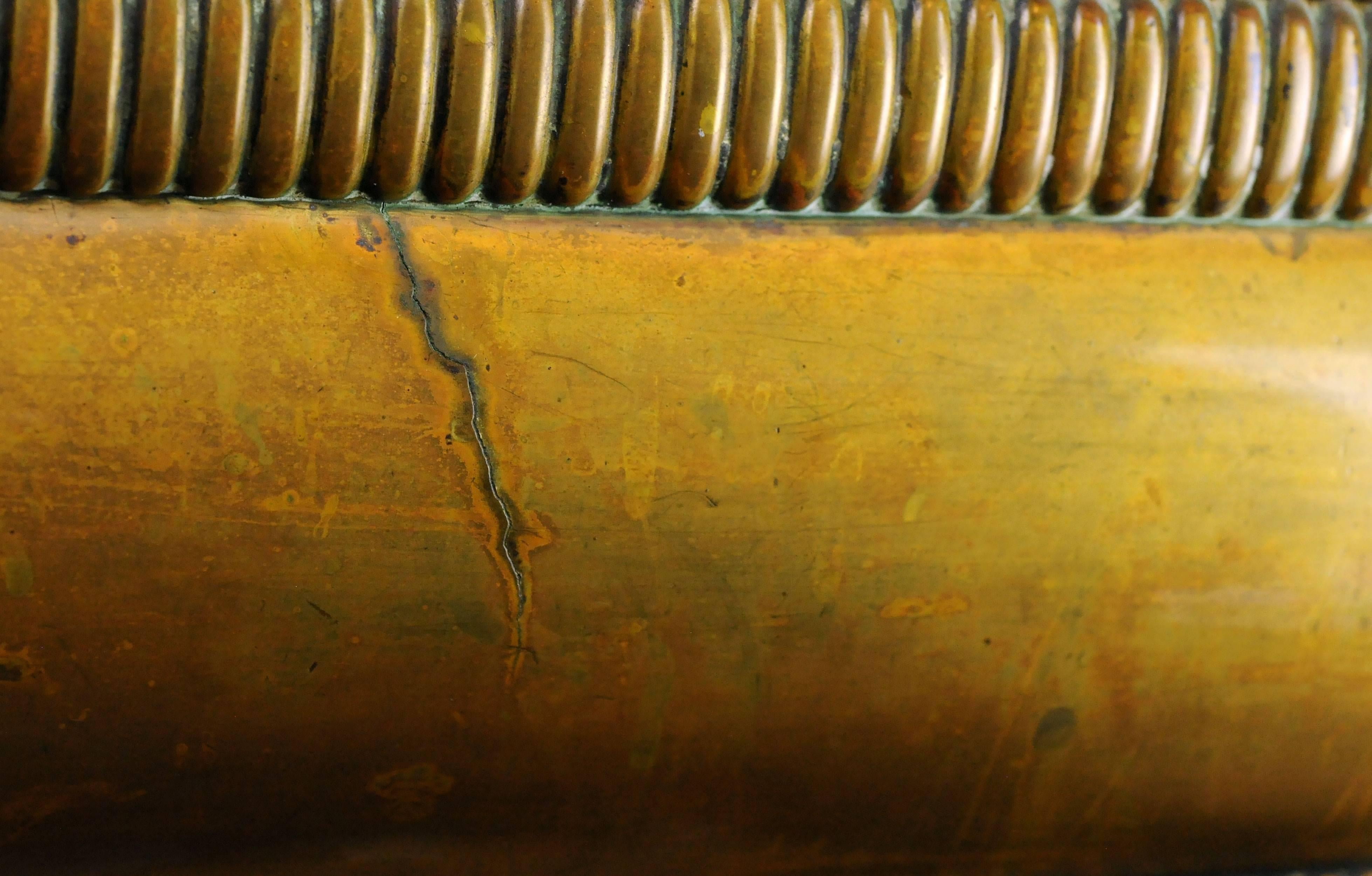 This heavy cast brass fireplace fender is complete with lion's paw feet and has a simple and elegant detailing, suitable for many fireplace hearths. A mix of brass and iron underneath, to protect the unit from high heats. The original patina shines