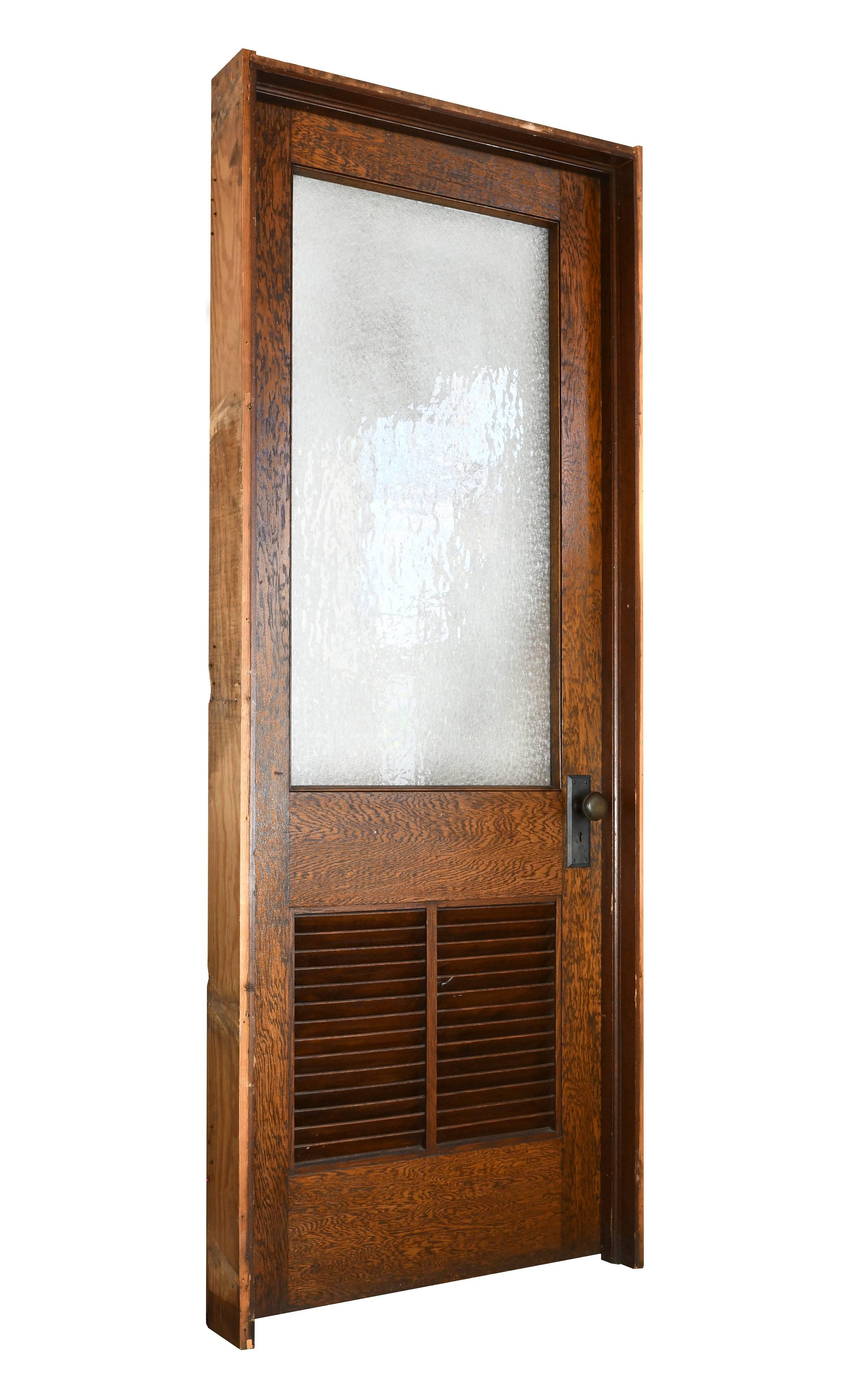 These oak schoolhouse doors feature highly contrasted wood grain, textured snowflake glass, wooden vent slats, and iron hardware. Originally from a schoolhouse in Youngstown, Ohio, these doors have stood the test of time with grace, and they're