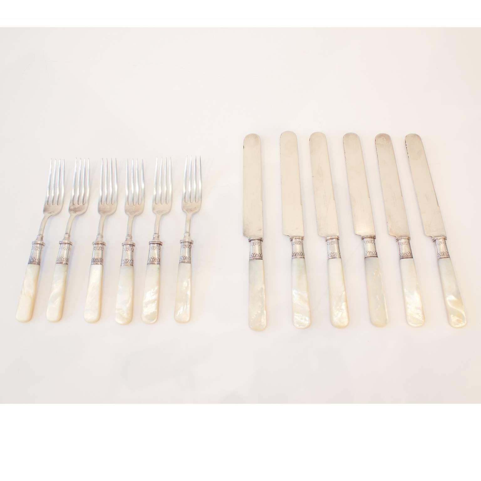 Rare Landers Frary & Clark knife and fork set for six people. These sterling silver forks and knives have exquisite mother-of-pearl handles, in good condition.

Forks measure 7.25